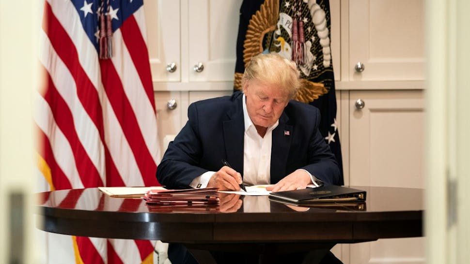 President Trump Tests Positive For Coronavirus In this handout provided by The White House, President Donald J. Trump works in the Presidential Suite at Walter Reed National Military Medical Center after testing positive for COVID-19 on October 3, 2020 in Bethesda, Maryland.