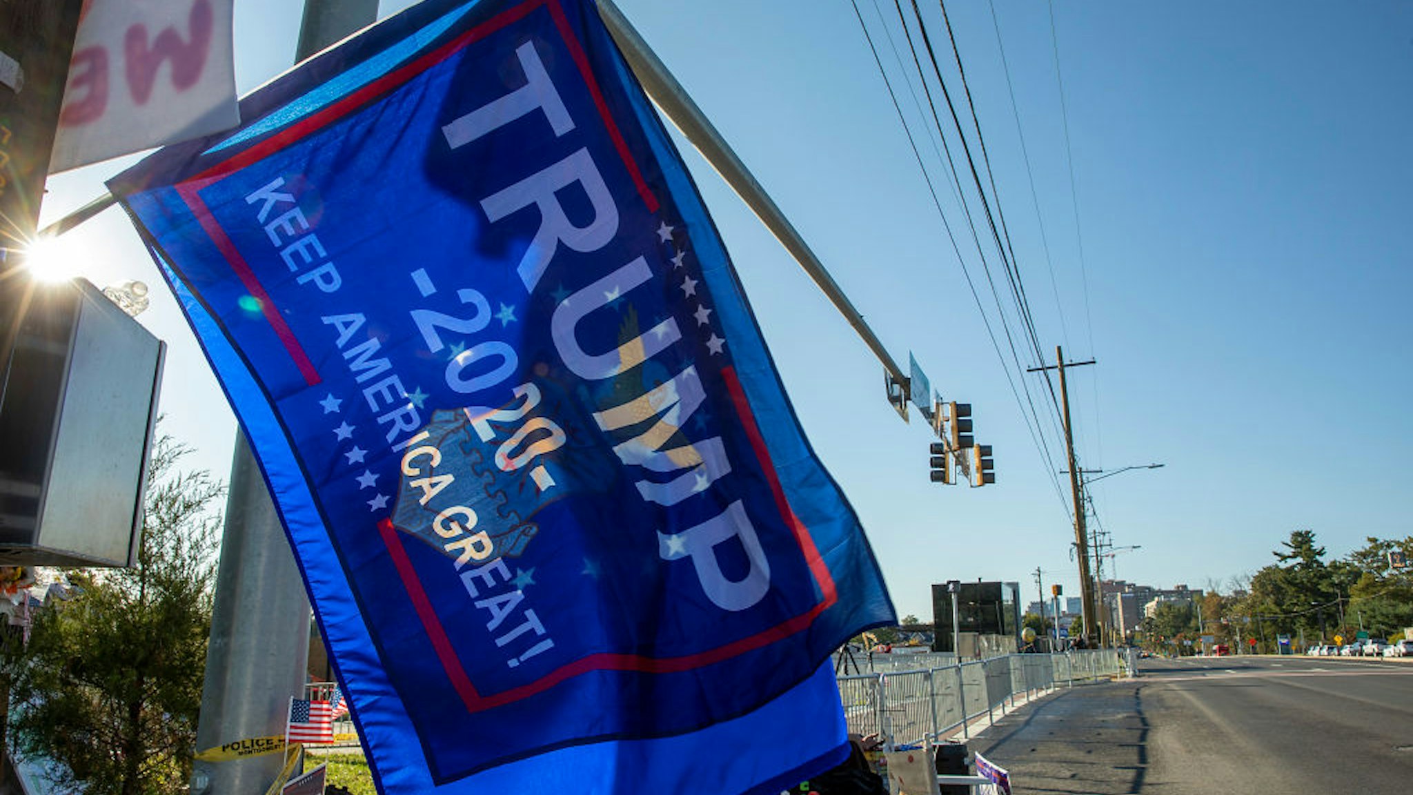 Supporters of President Donald Trump fly a banner outside Walter Reed National Military Medical Center after the President was admitted for treatment of COVID-19 on October 5, 2020 in Bethesda, Maryland.