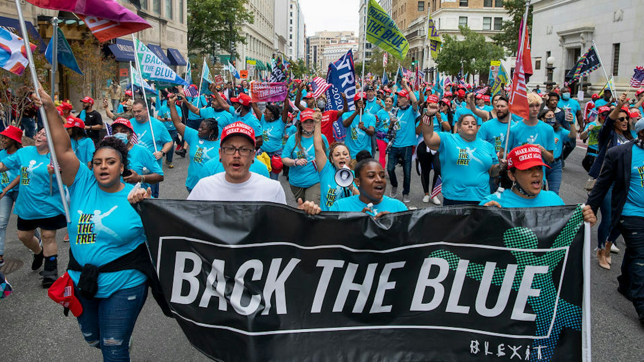 Members of Blexit march with the message "Back the Blue" after attending a rally on the South Lawn of the White House hosted by U.S. President Donald Trump on October 10, 2020 in Washington, DC.