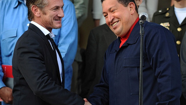 Venezuelan President Hugo Chavez (R) greets US actor Sean Penn after a meeting in Miraflores presidential palace in Caracas on March 5, 2011.
