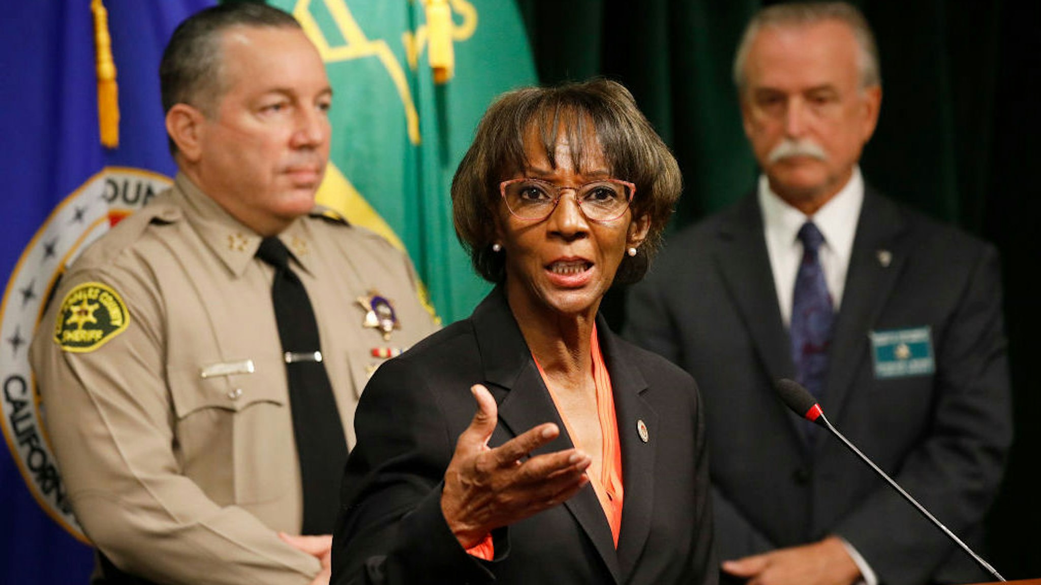 District Attorney Jackie Lacey, Los Angeles County Sheriff Alex Villanueva, left, and Homicide Bureau Captain Kent A. Wegener, right, announce an arrest of Deonte Lee Murray in the ambush shooting of two on-duty deputies who were sitting in their marked patrol car at the Metro Blue Line station in Compton September 12, 2020. Hall Of Justice on Wednesday, Sept. 30, 2020 in Los Angeles, CA. (Al Seib / Los Angeles Times