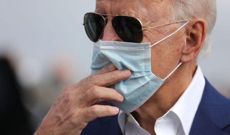 NEW CASTLE, DE - OCTOBER 13: Wearing a face mask to reduce the risk posed by the coronavirus, Democratic presidential nominee Joe Biden speaks briefly with reporters before boarding a flight to Florida at New Castle County Airport October 13, 2020 in New Castle, Delaware. Biden is traveling to Florida to campaign in Pembroke Pines and Miramar. (Photo by Chip Somodevilla/Getty Images)