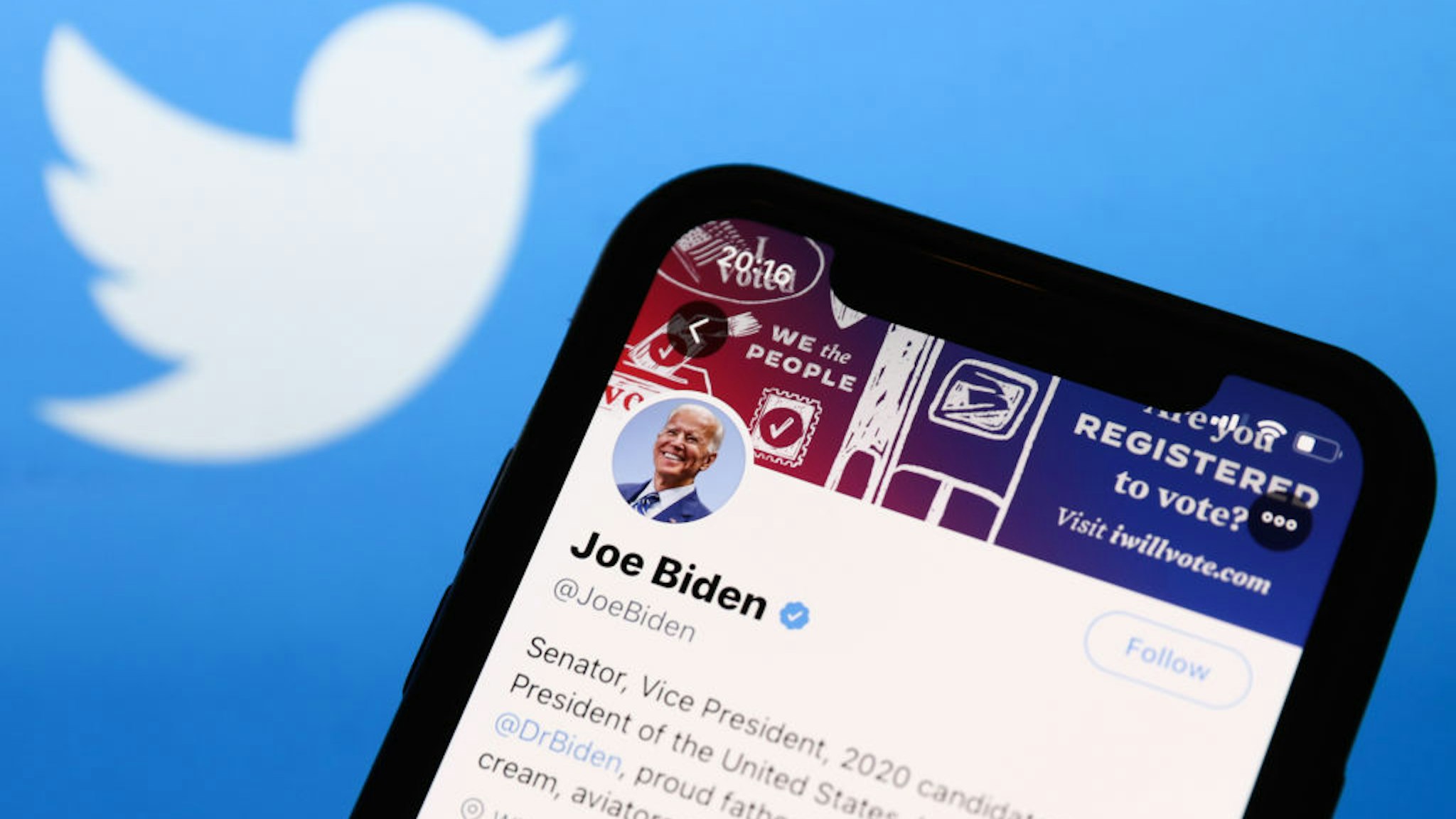 Twitter feed of candidate for President of the USA Joe Biden is seen displayed on a phone screen with Twitter logo in the background in this illustration photo taken on October 18, 2020. (Photo Illustration by Jakub Porzycki/NurPhoto via Getty Images)