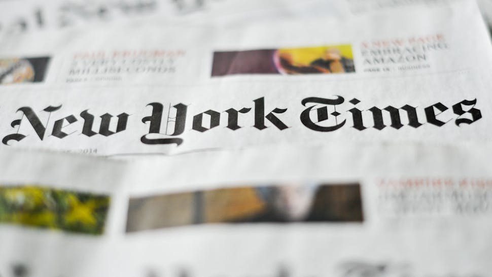 ILLUSTRATION - Various editions of the New York Times newspaper are on display on a table in Berlin, Germany, 23 April 2014. Photo: Ole Spata/dpa | usage worldwide (Photo by Ole Spata/picture alliance via Getty Images)