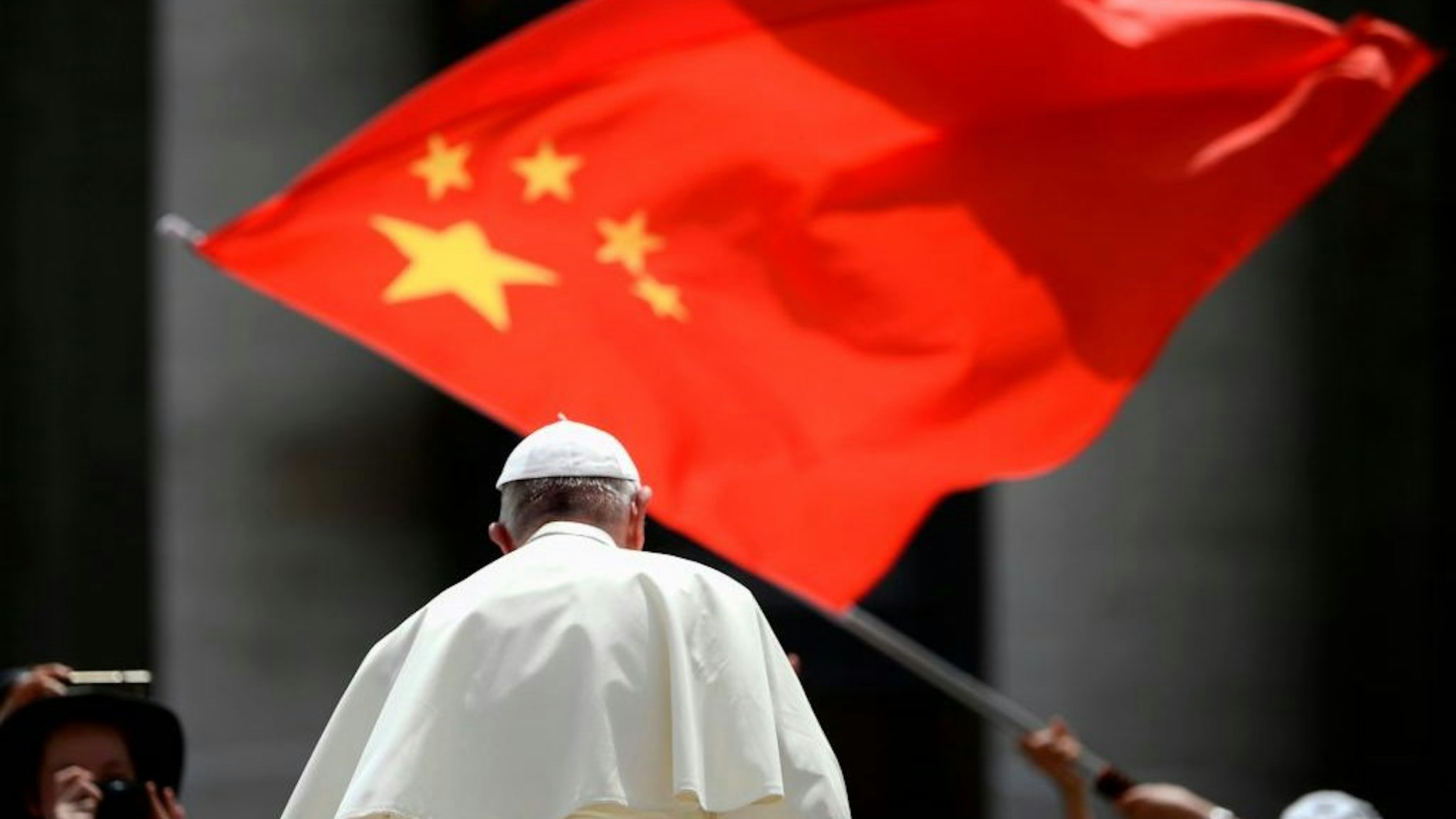 A worshipers waves the flag of China as Pope Francis leaves following the weekly general audience on June 12, 2019 at St. Peter's square in the Vatican. (Photo by Filippo MONTEFORTE / AFP) (Photo credit should read FILIPPO MONTEFORTE/AFP via Getty Images)