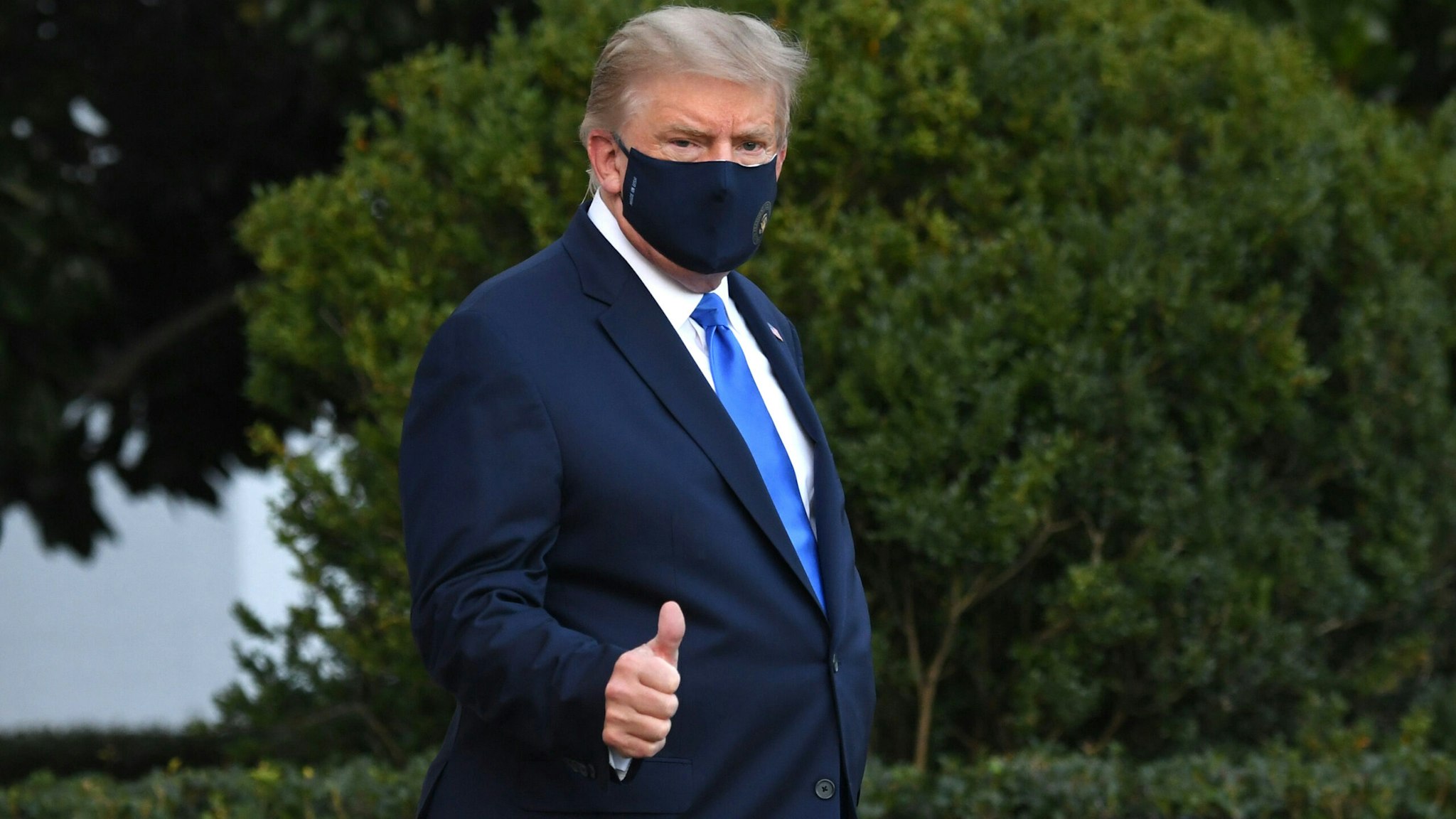 US President Donald Trump gives a thumbs up as he walks to Marine One prior to departure from the South Lawn of the White House in Washington, DC, October 2, 2020, as he heads to Walter Reed Military Medical Center, after testing positive for Covid-19. - President Donald Trump will spend the coming days in a military hospital just outside Washington to undergo treatment for the coronavirus, but will continue to work, the White House said Friday