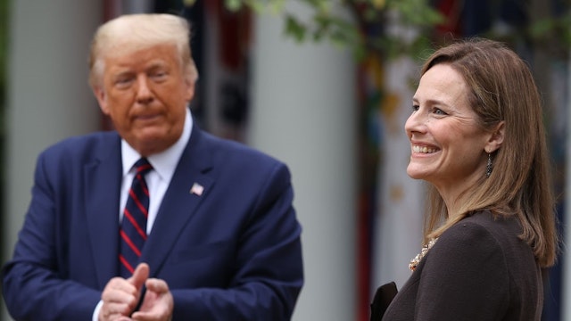 WASHINGTON, DC - SEPTEMBER 26: U.S. President Donald Trump (L) introduces 7th U.S. Circuit Court Judge Amy Coney Barrett as his nominee to the Supreme Court in the Rose Garden at the White House September 26, 2020 in Washington, DC. With 38 days until the election, Trump tapped Barrett to be his third Supreme Court nominee in just four years and to replace the late Associate Justice Ruth Bader Ginsburg, who will be buried at Arlington National Cemetery on Tuesday. (Photo by