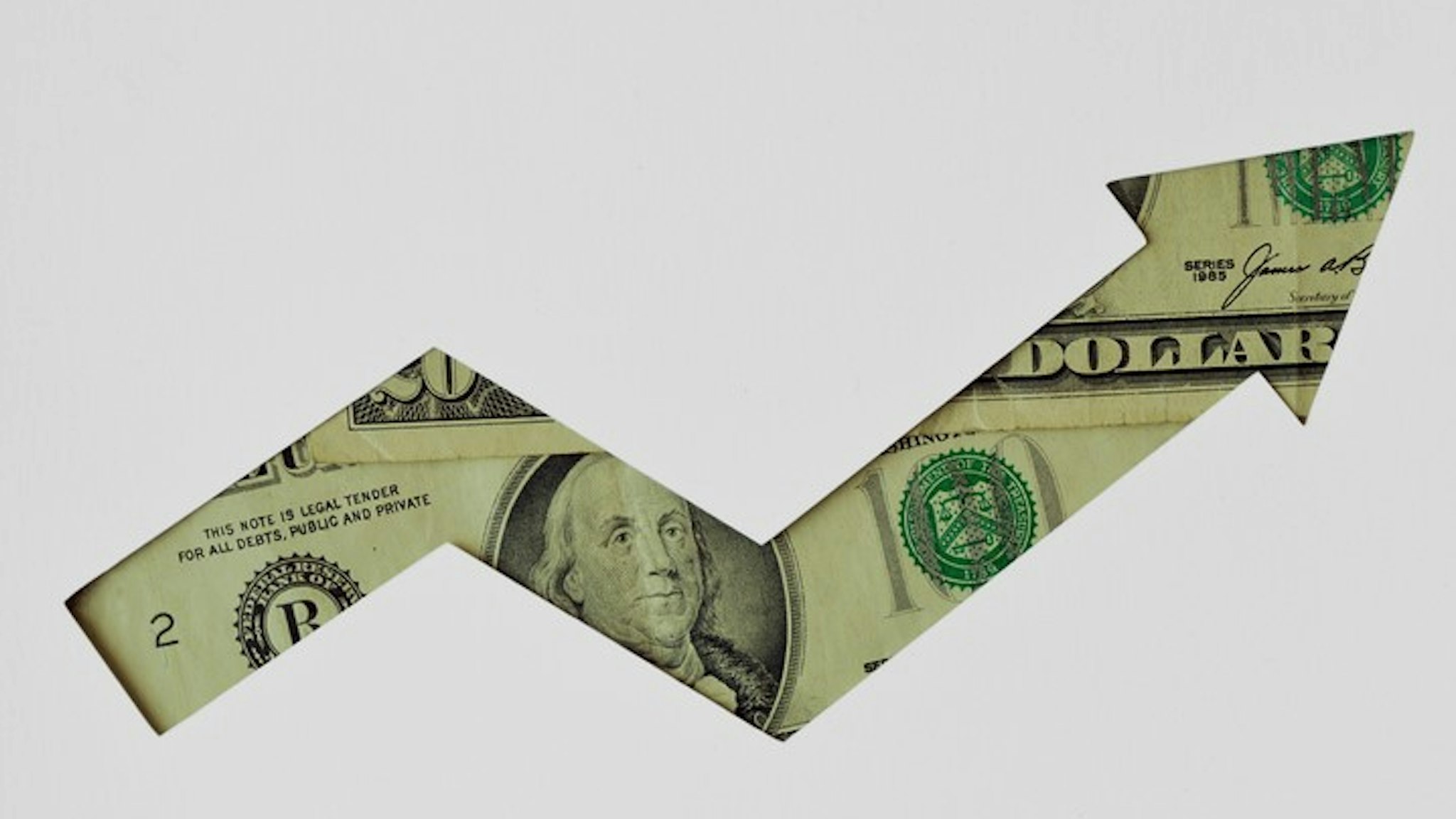 Upward arrow made of dollar banknotes on white background - Concept of upward trend of dollar currency