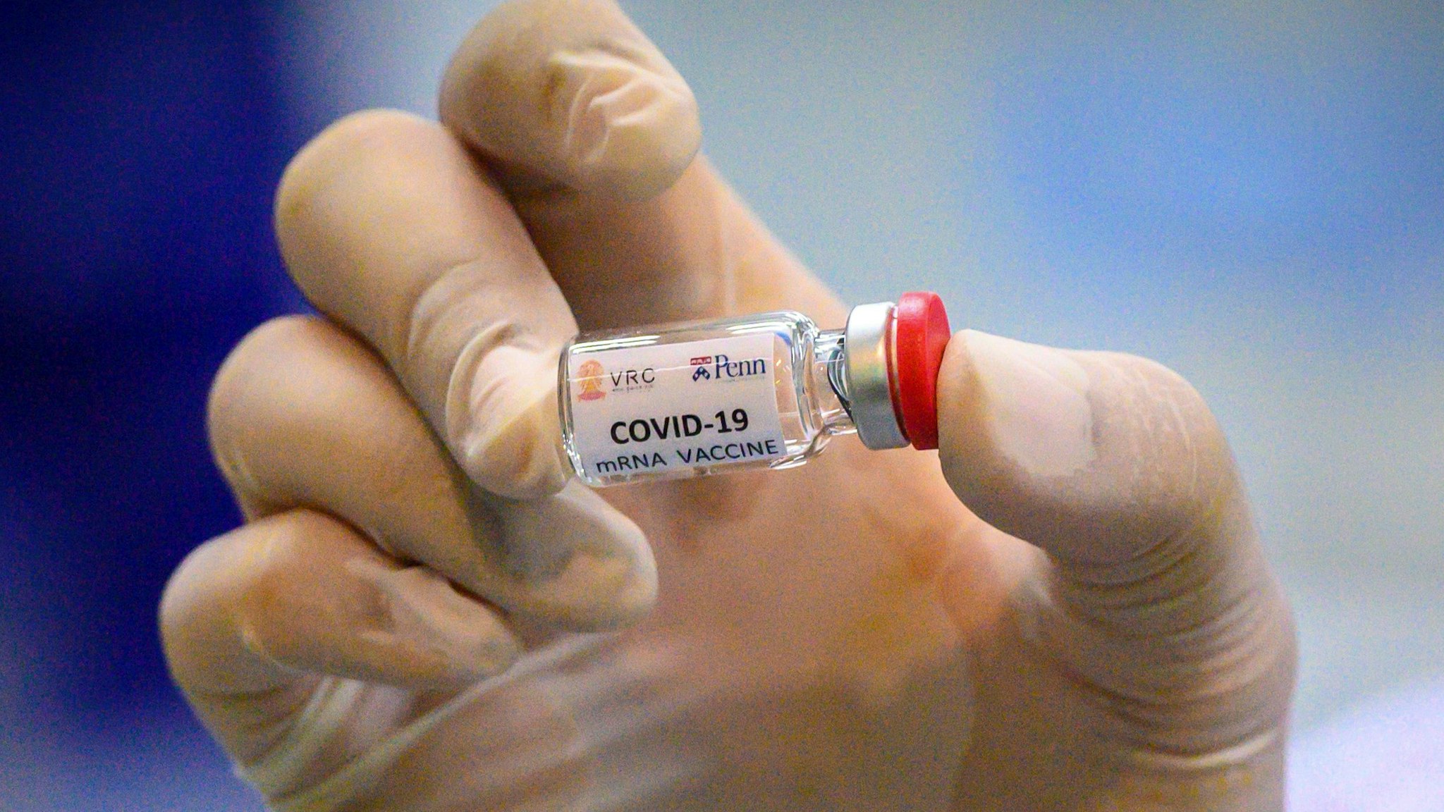 This picture taken on May 23, 2020 shows a laboratory technician holding a dose of a COVID-19 novel coronavirus vaccine candidate ready for trial on monkeys at the National Primate Research Center of Thailand at Chulalongkorn University in Saraburi. - After conclusive results on mice, Thai scientists from the centre have begun testing a COVID-19 novel coronavirus vaccine candidate on monkeys, the phase before human trials.