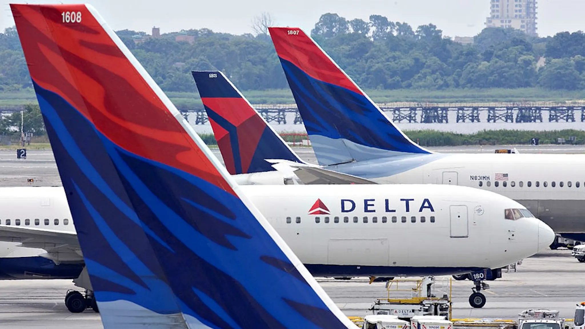 A Delta Air Lines plane taxis toward a gate between other De UNITED STATES - JULY 20: A Delta Air Lines plane taxis toward a gate between other Delta planes at John F. Kennedy International Airport in New York, U.S., on Monday, July 20, 2009. Delta Air Lines Inc., based in Atlanta since 1941, is promoting itself as New York city's "hometown carrier" with mojitos in Manhattan and sponsorships of the Yankees and Mets baseball teams. (Photo by