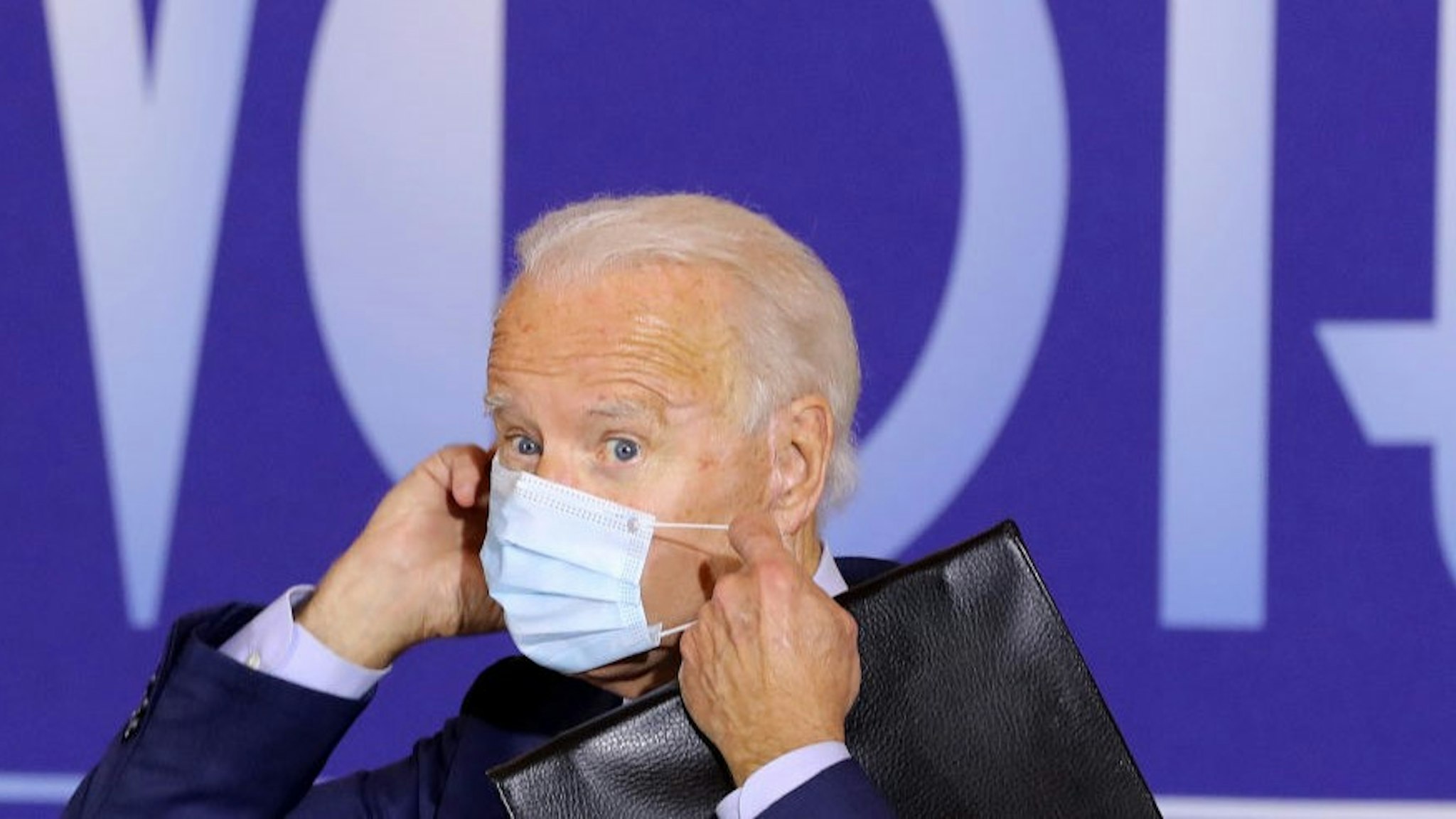 CINCINNATI, OH - OCTOBER 12: Democratic presidential nominee Joe Biden replaces his face mask after delivering remarks during a voter-mobilization event at the Cincinnati Museum Center at Union Terminal October 12, 2020 in Cincinnati, Ohio. With 21 days until the election, Biden is campaigning in Toledo and Cincinnati. (Photo by