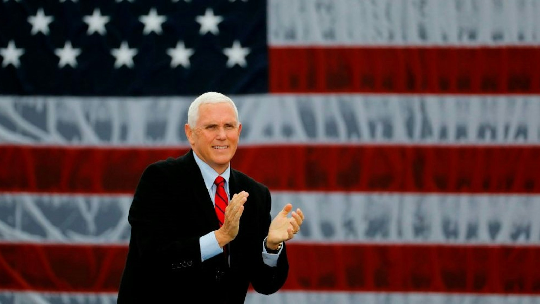 US Vice President Mike Pence walks on stage at a "Make America Great Again!" campaign event at Oakland County International Airport in Waterford, Michigan, on October 22, 2020. (Photo by JEFF KOWALSKY / AFP) (Photo by