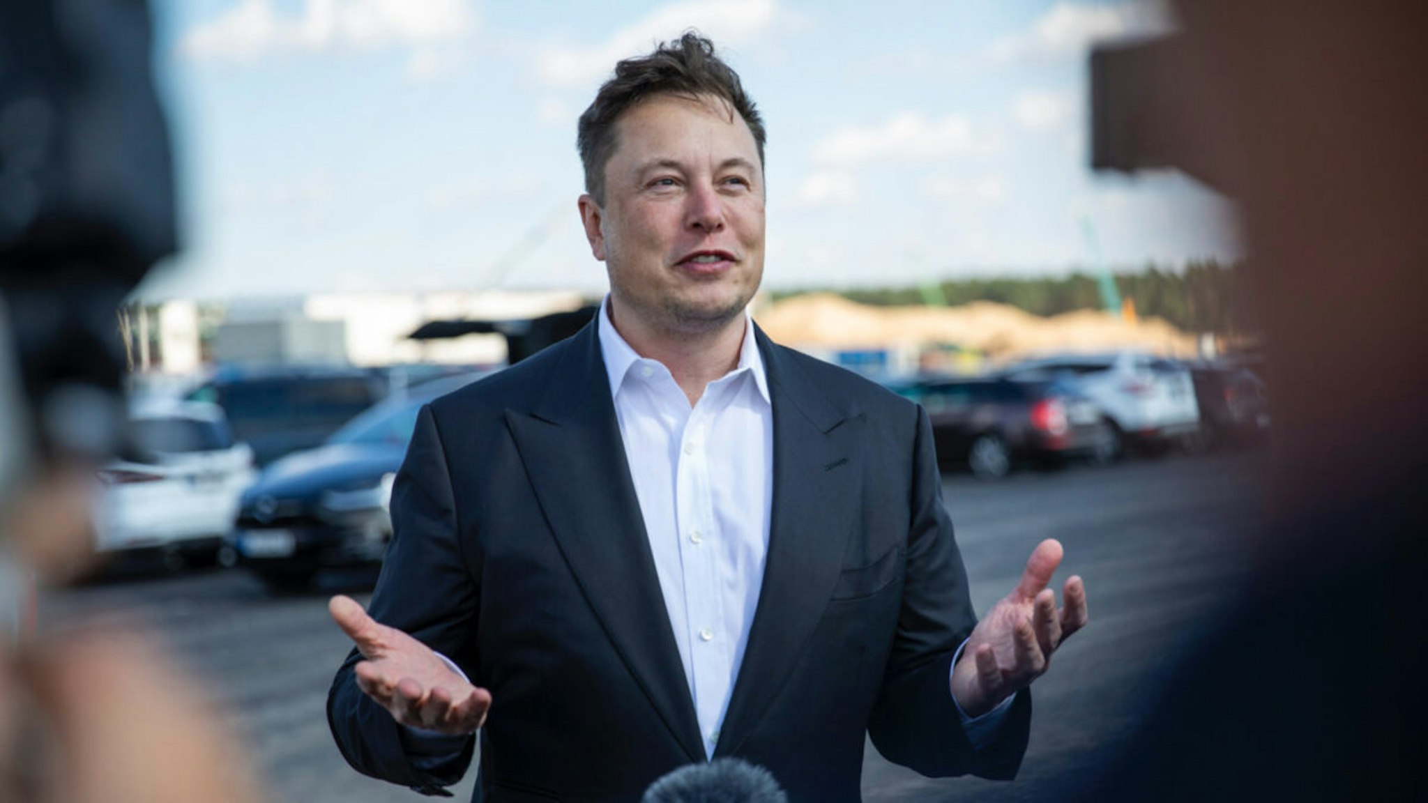 Tesla head Elon Musk talks to the press as he arrives to to have a look at the construction site of the new Tesla Gigafactory near Berlin on September 03, 2020 near Gruenheide, Germany.
