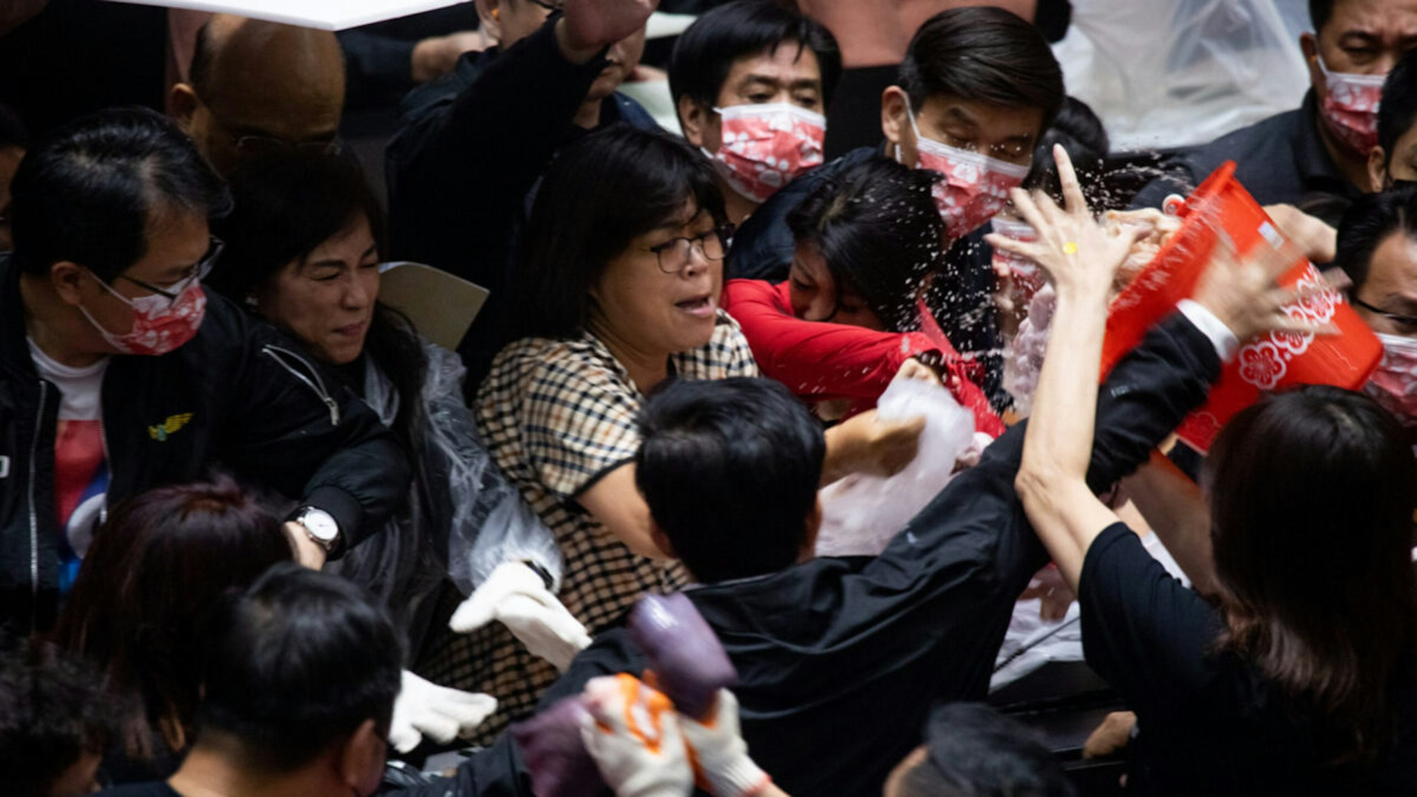 Kuomintang (KMT) legislators throw pig offal on the podium in Taiwan parliament in Taipei, Taiwan, on 27 November 2020.