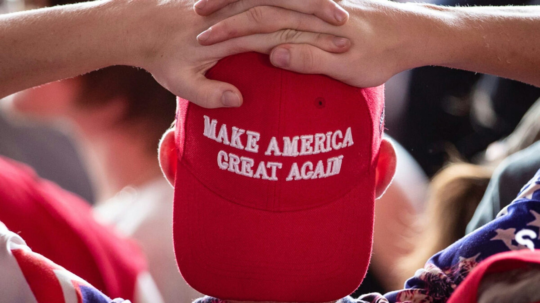 A man wears a 'Make America Great Again' hat as he waits for U.S. President Donald Trump to arrive for a 'Make America Great Again' campaign rally at Williamsport Regional Airport, May 20, 2019 in Montoursville, Pennsylvania.