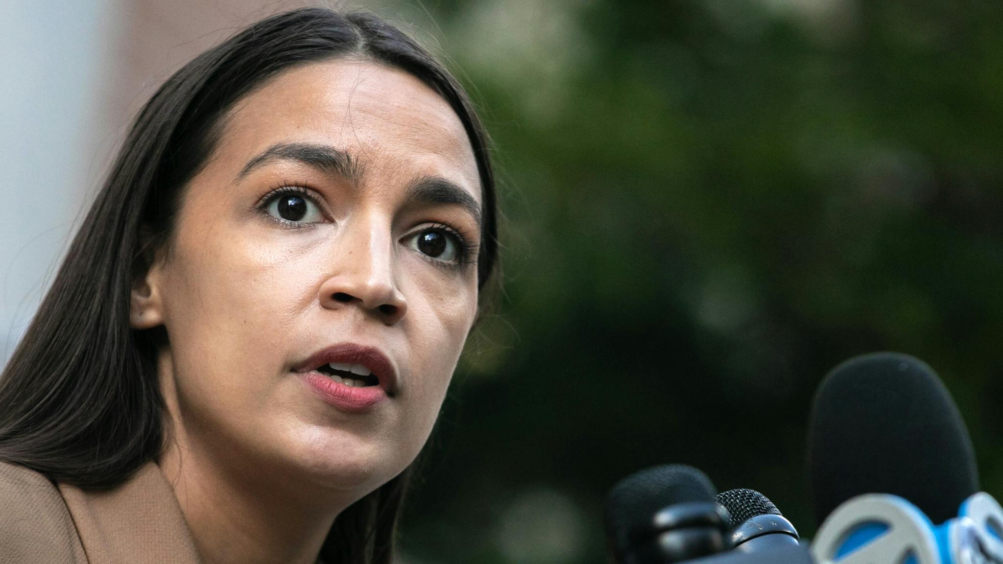 Representative Ocasio-Cortez Holds News Conference At U.S. Post Office On Day Of Action Representative Alexandria Ocasio-Cortez, a Democrat from New York, speaks during a news conference outside a U.S. Postal Service post office in the Queens borough of New York, U.S., on Tuesday, Aug. 18, 2020. Speaker Nancy Pelosi, who is calling the House back to vote on legislation to halt post office cutbacks and give the agency $25 billion in additional funding, appealed to House members to participate in a day of action today by appearing at a post office in their districts.
