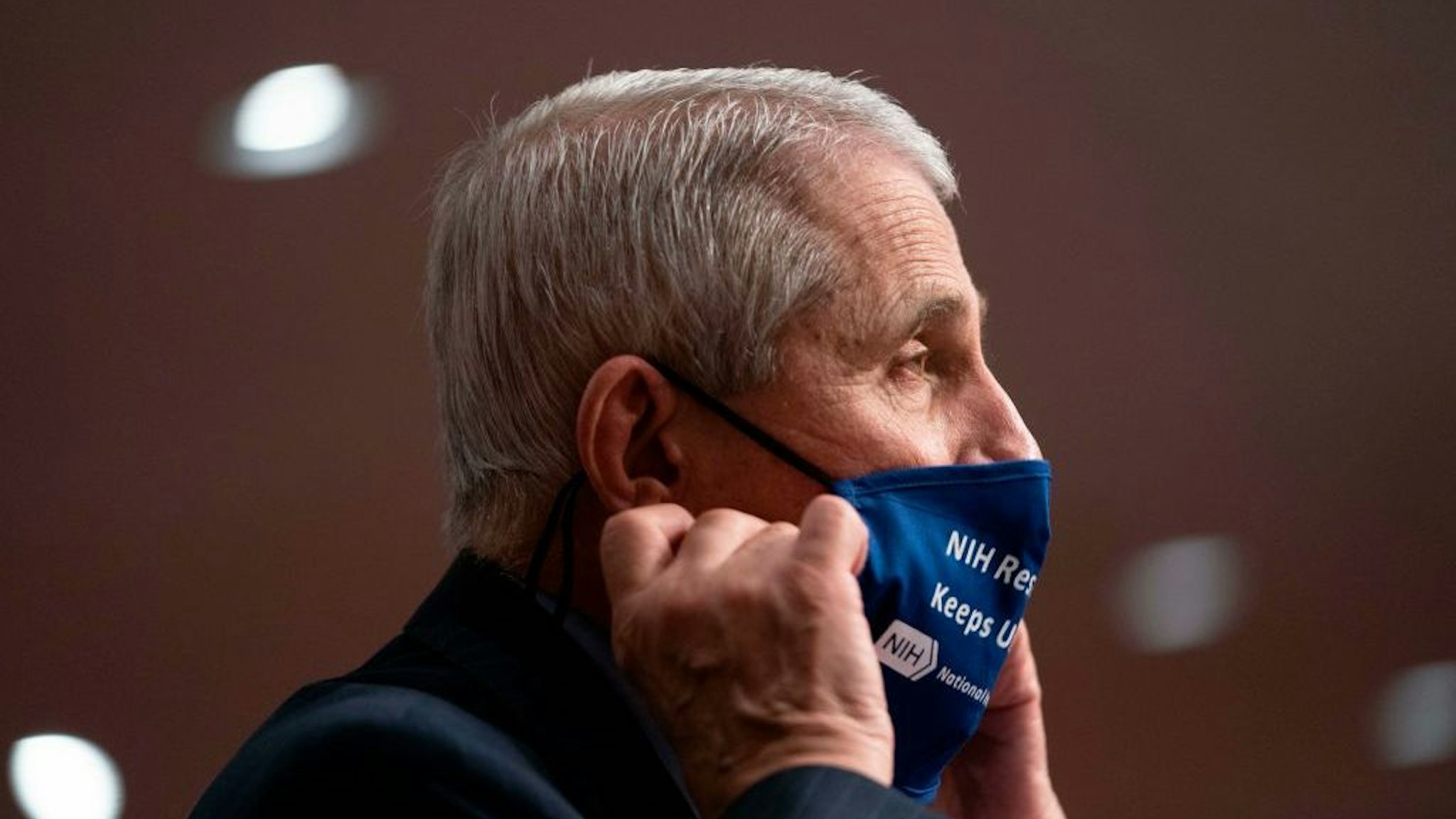 Dr. Anthony Fauci,Director, National Institute of Allergy and Infectious Diseases, National Institutes of Health, removes his mask as he testifies during a US Senate Senate Health, Education, Labor, and Pensions Committee hearing to examine covid-19, focusing on an update on the federal response in Washington, DC, on September 23, 2020. (Photo by Alex Edelman / POOL / AFP) (Photo by ALEX EDELMAN/POOL/AFP via Getty Images)