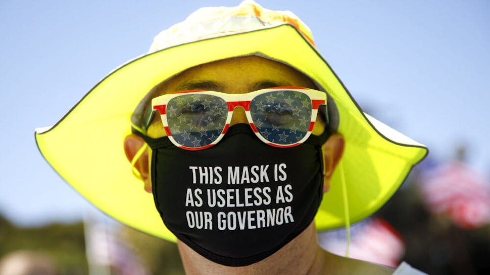 US-POLITICS-TRUMP-RALLY A demonstrator wears a facemask referring to the governor of California during a WalkAway rally in support of the US president on August 8, 2020 in Beverly Hills, California.