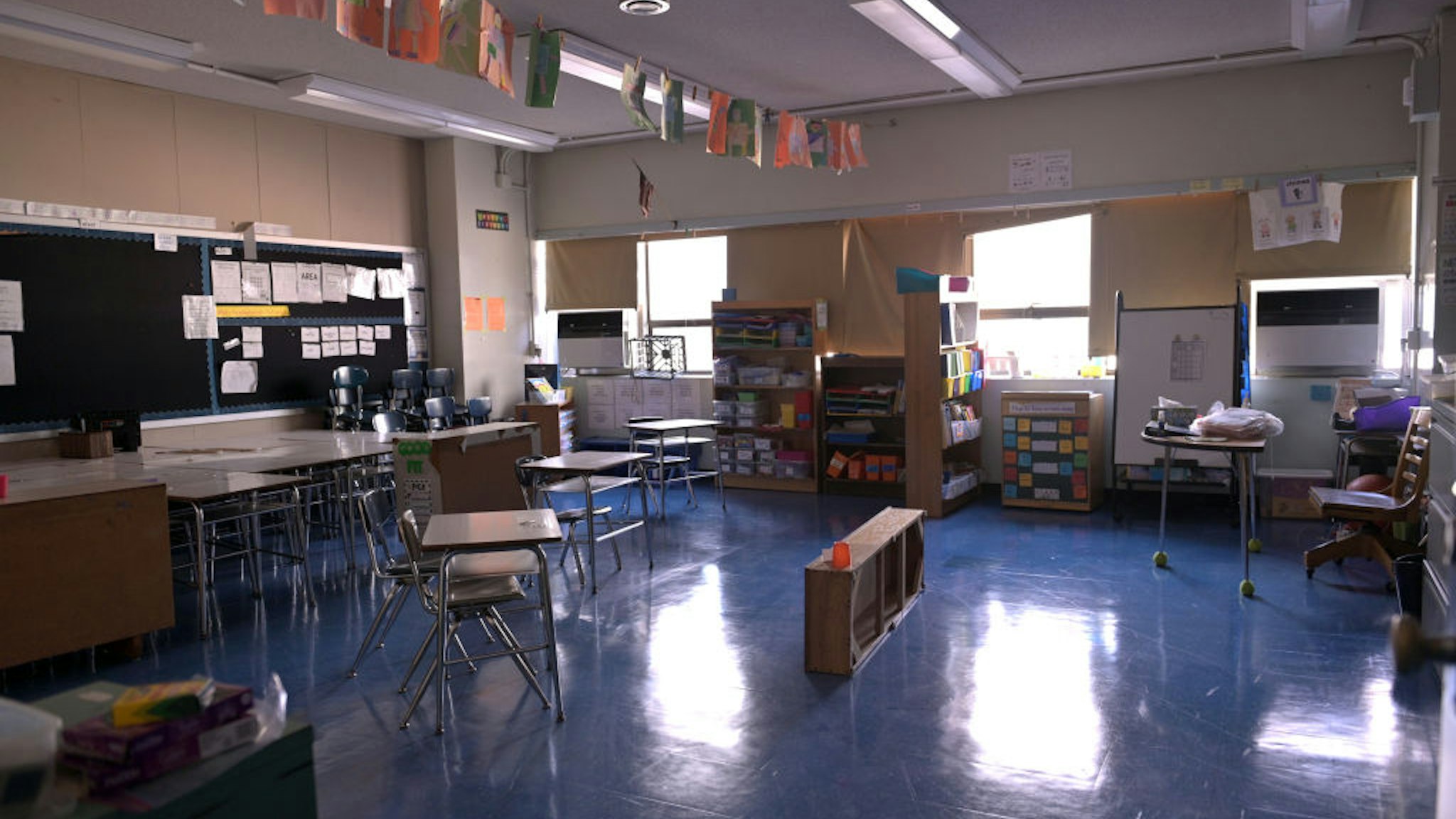 NEW YORK, NEW YORK - NOVEMBER 19: A classroom is empty with the lights off on what would otherwise be a blended learning school day on November 19, 2020 at Yung Wing School P.S. 124 in New York City. NYC Mayor Bill DeBlasio had to return the nation’s largest district had to all-remote teaching/learning as of today, with an indefinite outlook for reopening.
