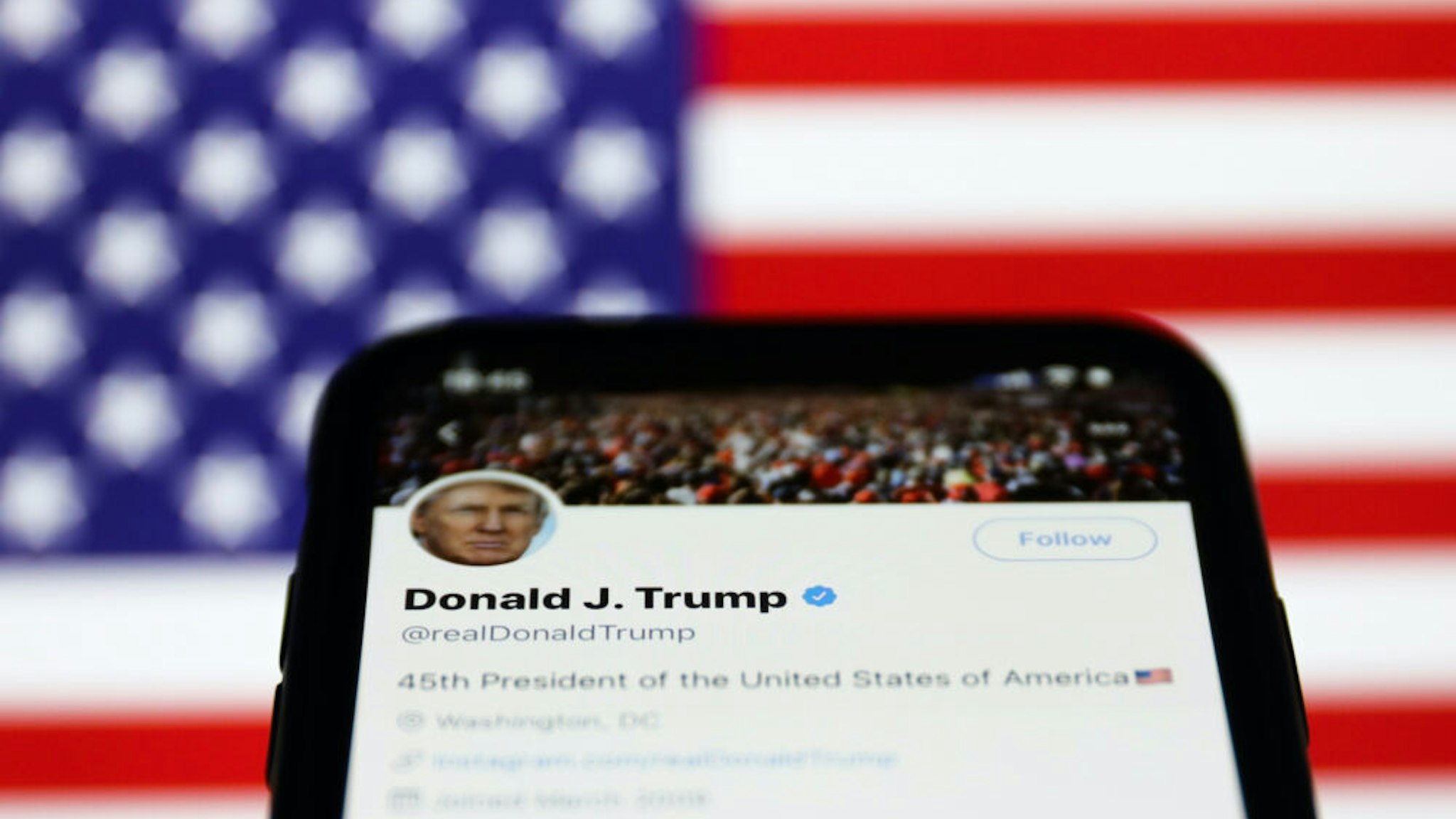 Twitter feed of the President of the USA Donald Trump is seen displayed on a phone screen with American flag in the background in this illustration photo taken on October 18, 2020. (Photo Illustration by Jakub Porzycki/NurPhoto via Getty Images)