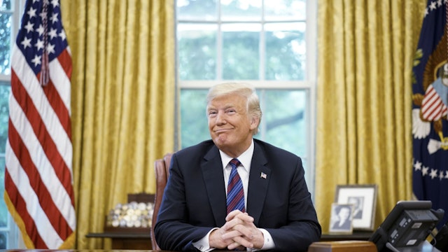 US President Donald Trump smiles during a phone conversation with Mexico's President Enrique Pena Nieto on trade in the Oval Office of the White House in Washington, DC on August 27, 2018. - President Donald Trump said Monday the US had reached a "really good deal" with Mexico and talks with Canada would begin shortly on a new regional free trade pact."It's a big day for trade. It's a really good deal for both countries," Trump said."Canada, we will start negotiations shortly. I'll be calling their prime minister very soon," Trump said.US and Mexican negotiators have been working for weeks to iron out differences in order to revise the nearly 25-year old North American Free Trade Agreement, while Canada was waiting to rejoin the negotiations. (Photo by MANDEL NGAN / AFP) (Photo by MANDEL NGAN/AFP via Getty Images)