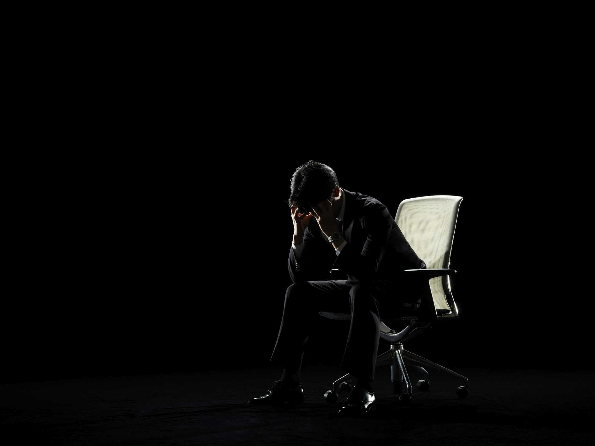 Businessman who sits on chair and worries - stock photo