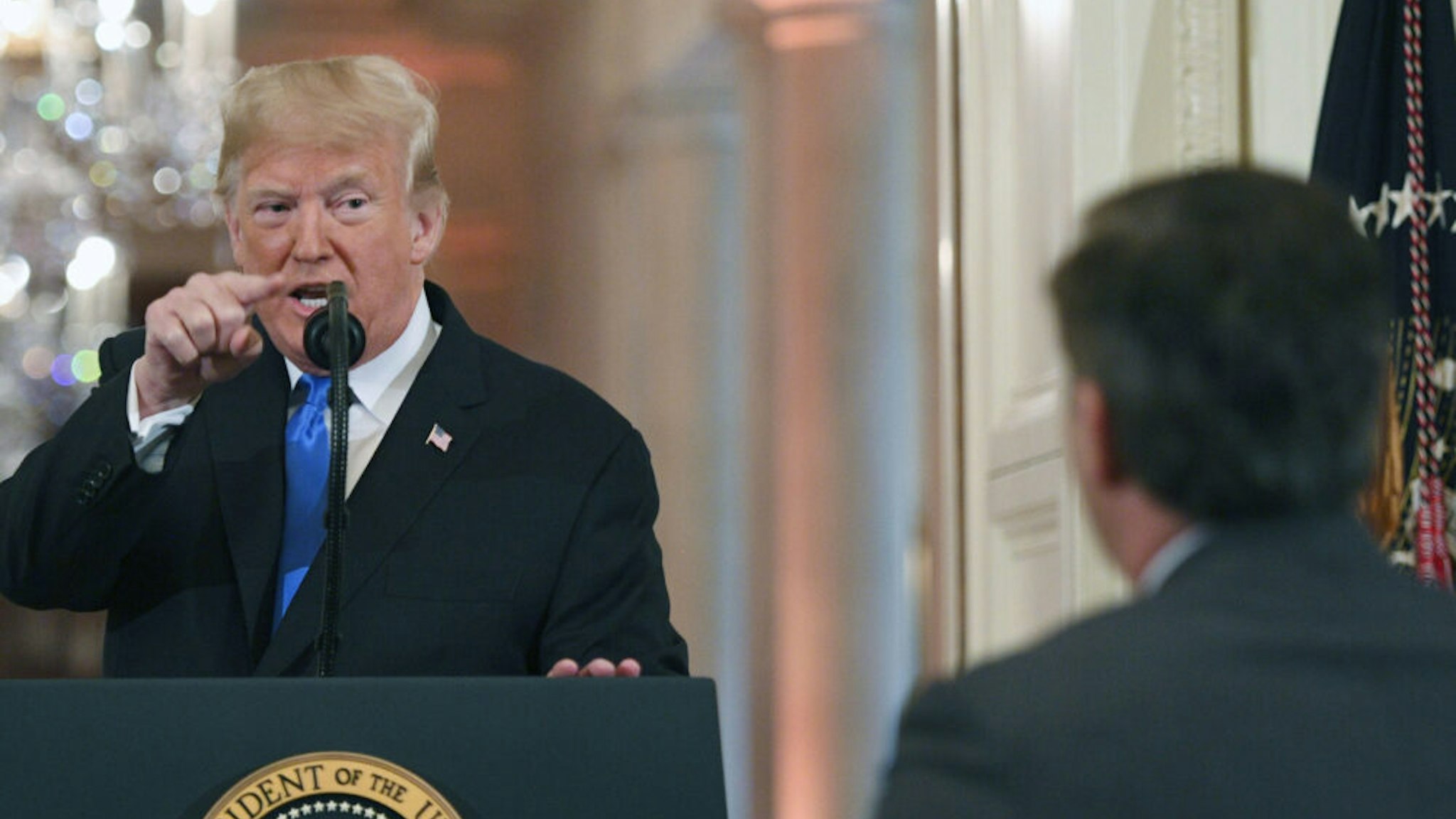 TOPSHOT - US President Donald Trump points to journalist Jim Acosta from CNN during a post-election press conference in the East Room of the White House in Washington, DC on November 7, 2018. (Photo by Jim WATSON / AFP)