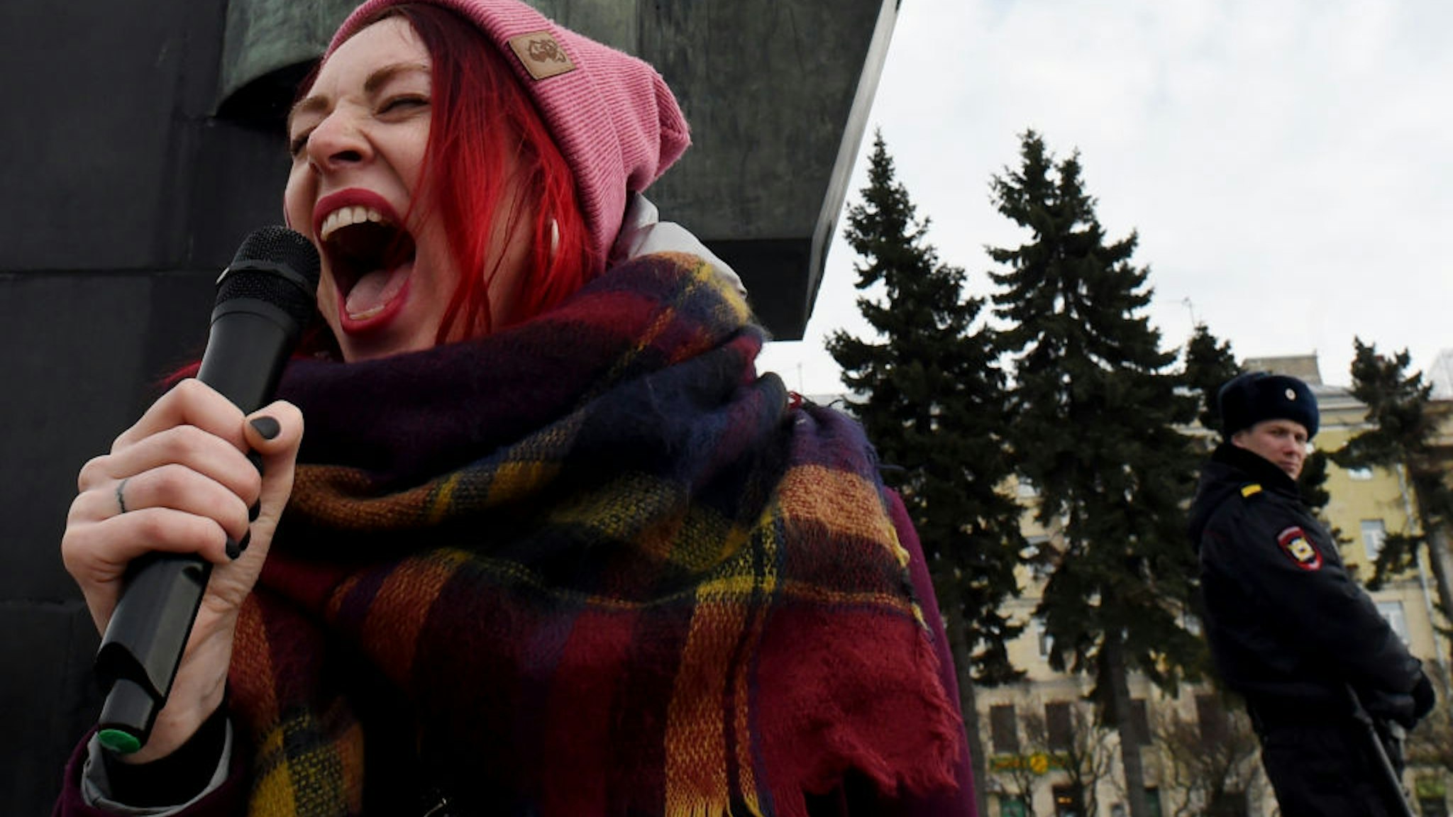 A feminist activist shouts slogans in a microphone during a rally for gender equality and women's rights in Saint Petersburg, on March 8, 2019, as International Women's Day is being celebrated around the world.