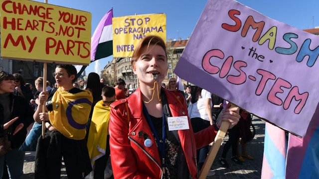 Protesters blow whistles during a transgender march in downtown Zagreb on March 30, 2019. - About 300 people, coming from all over the largely conservative Balkans region, took part in Croatia's first ever transgender march through downtown Zagreb. Organisers say they are sending clear messages of pride and defiance as well as against all forms of oppression. (Photo by Denis LOVROVIC / AFP) (Photo credit should read DENIS LOVROVIC/AFP via Getty Images)