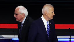 Joe Biden and Bernie Sanders MIAMI, FLORIDA - JUNE 27: Democratic presidential candidates Sen. Bernie Sanders (L) (I-VT) and former Vice President Joe Biden pass each other on stage during the second night of the first Democratic presidential debate on June 27, 2019 in Miami, Florida. A field of 20 Democratic presidential candidates was split into two groups of 10 for the first debate of the 2020 election, taking place over two nights at Knight Concert Hall of the Adrienne Arsht Center for the Performing Arts of Miami-Dade County, hosted by NBC News, MSNBC, and Telemundo.