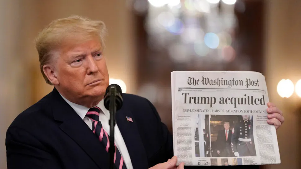 Trump Impeachment WASHINGTON, DC - FEBRUARY 06: U.S. President Donald Trump holds a copy of The Washington Post as he speaks in the East Room of the White House one day after the U.S. Senate acquitted on two articles of impeachment, ion February 6, 2020 in Washington, DC. After five months of congressional hearings and investigations about President Trump’s dealings with Ukraine, the U.S. Senate formally acquitted the president on Wednesday of charges that he abused his power and obstructed Congress.