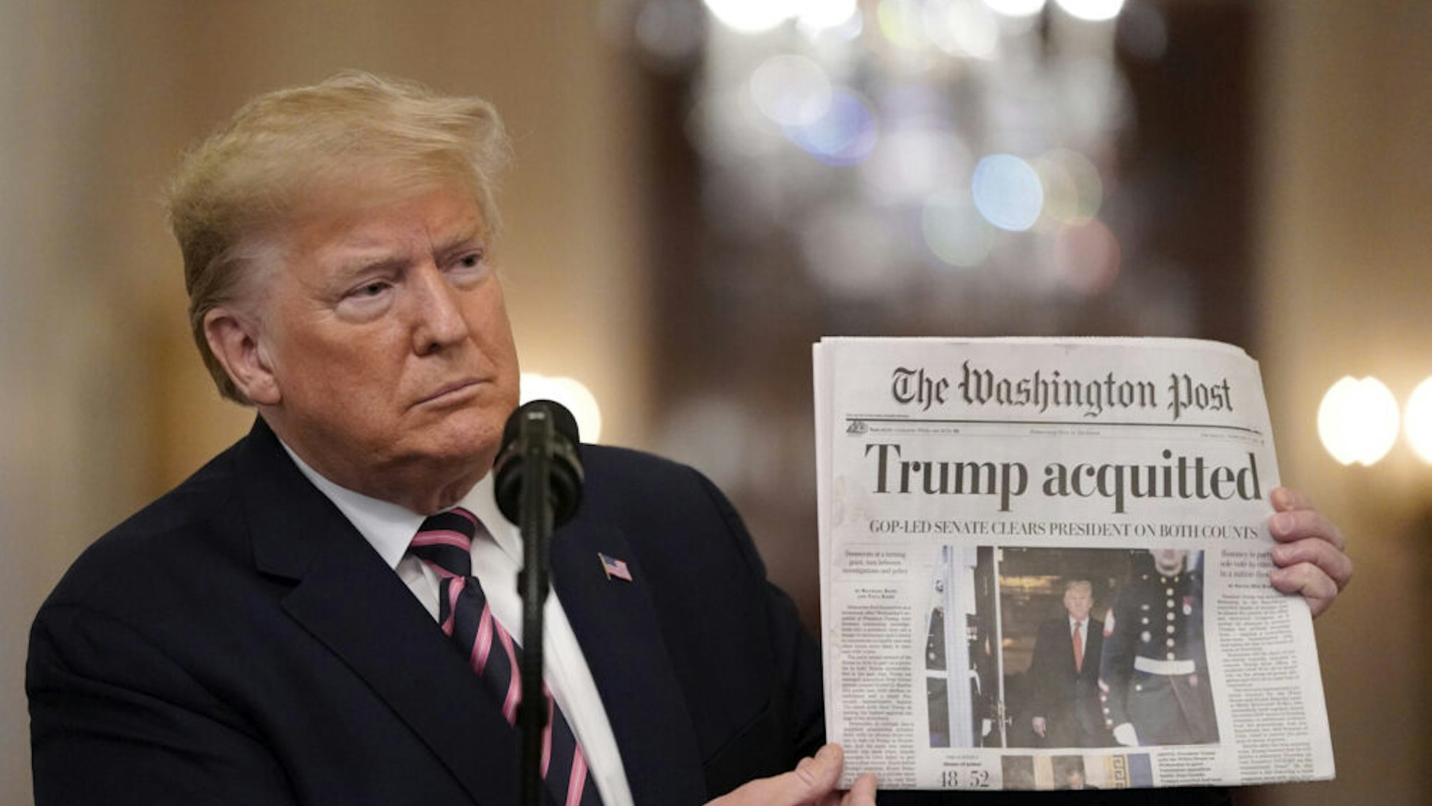 WASHINGTON, DC - FEBRUARY 06: U.S. President Donald Trump holds a copy of The Washington Post as he speaks in the East Room of the White House one day after the U.S. Senate acquitted on two articles of impeachment, ion February 6, 2020 in Washington, DC. After five months of congressional hearings and investigations about President Trump’s dealings with Ukraine, the U.S. Senate formally acquitted the president on Wednesday of charges that he abused his power and obstructed Congress.