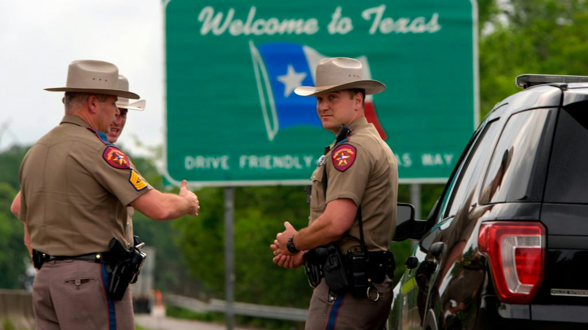 Texas State troopers patrol I-10 across the border from Louisiana on March 30, 2020 in Orange, Texas.