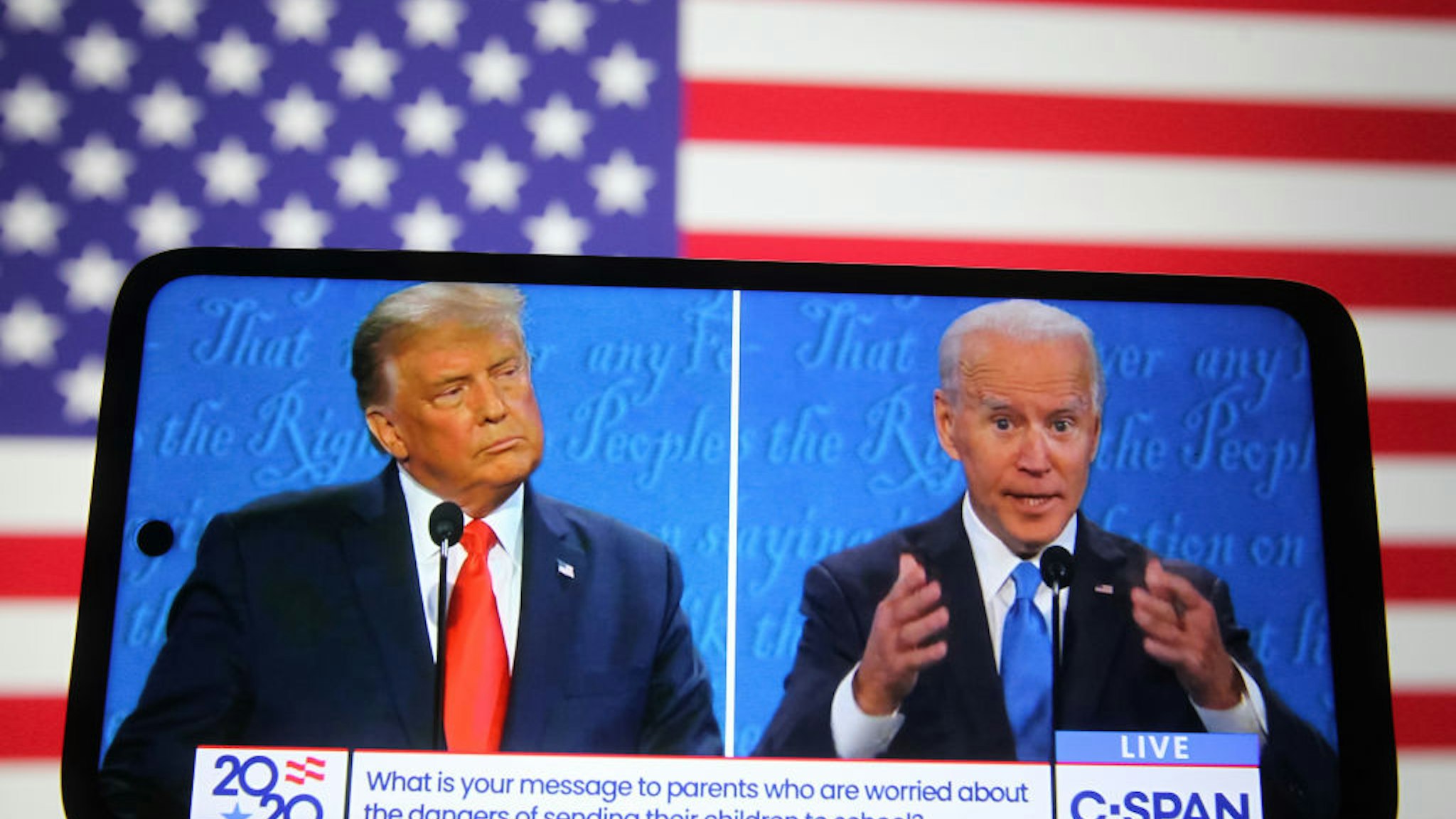 In this photo illustration the US President Donald Trump and Democratic presidential candidate and former US Vice President Joe Biden are seen during the final presidential debate displayed on a screen of a smartphone.