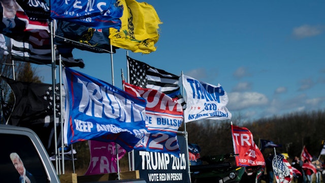 A truck supporting President Donald Trump flies flags as it drives past fellow supporters demonstrating across the street from a venue where Democratic U.S. Vice Presidential nominee Sen. Kamala Harris (D-CA) will hold a campaign event on the eve of the general election on November 2, 2020 in Bethlehem, Pennsylvania.