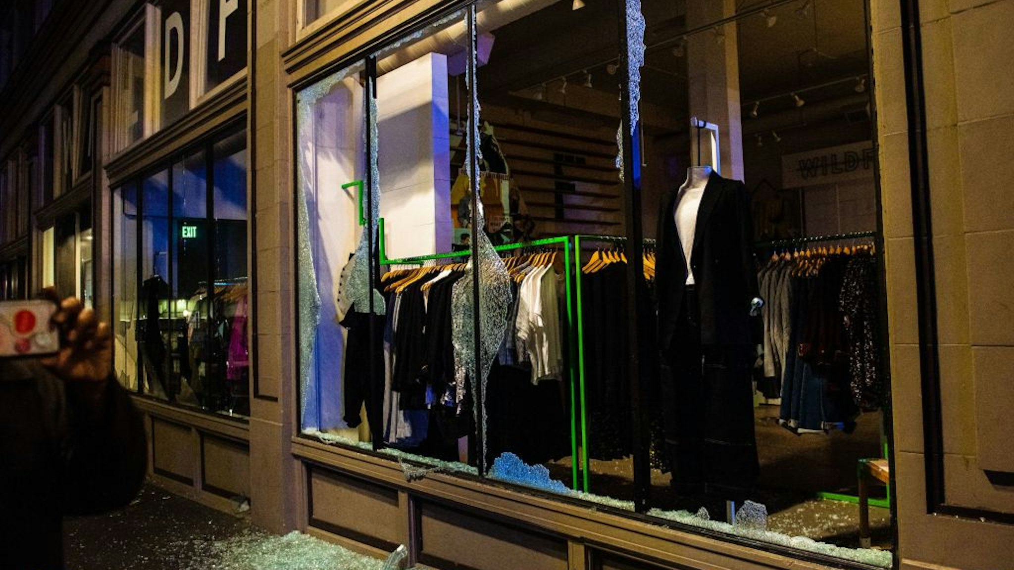 A clothing store is vandalized as police confront protesters in Portland, Oregon on November 4, 2020, during a demonstration called by the "Black Lives Matter" movement, a day after the US Presidential Election.