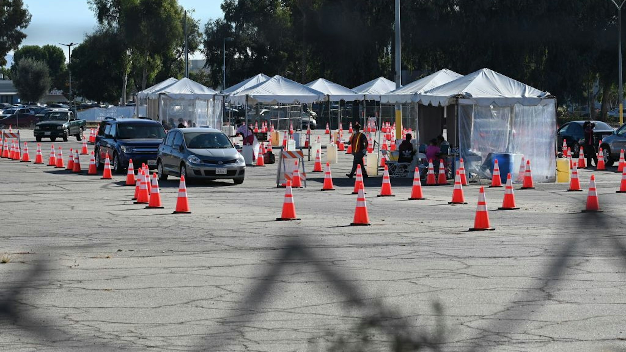 COVID-19 testing site staff directs traffic at a drive-up testing site in Los Angeles, California, November 17, 2020.