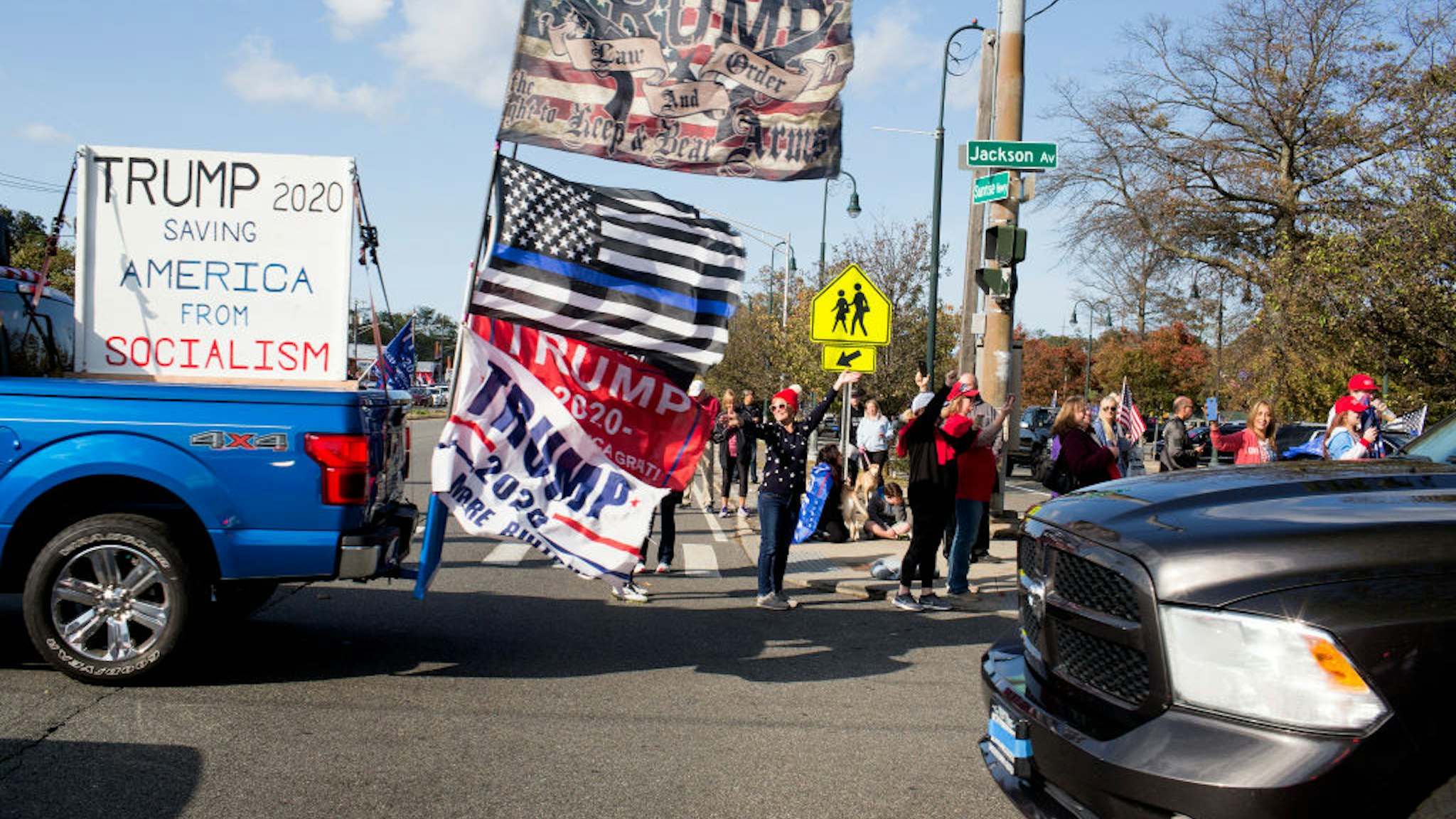Trump supporters gather in a Long Island Rail Road parking lot before driving in cars as part of a caravan on October 18, 2020 in Seaford, New York.