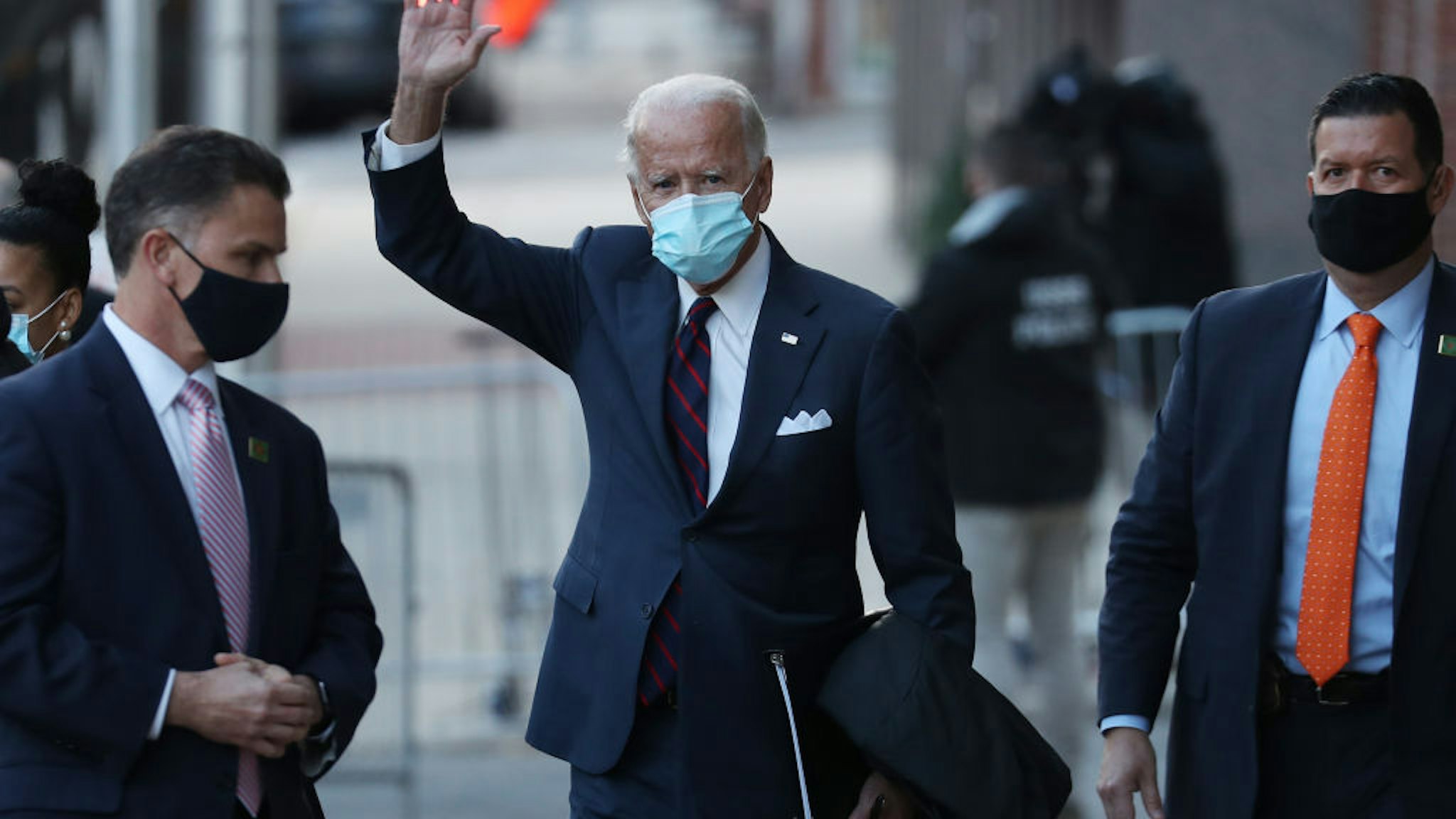U.S. President-elect Joe Biden waves as he leaves the Queen Theater after receiving a briefing on national security wiith advisors on November 17, 2020 in Wilmington, Delaware.
