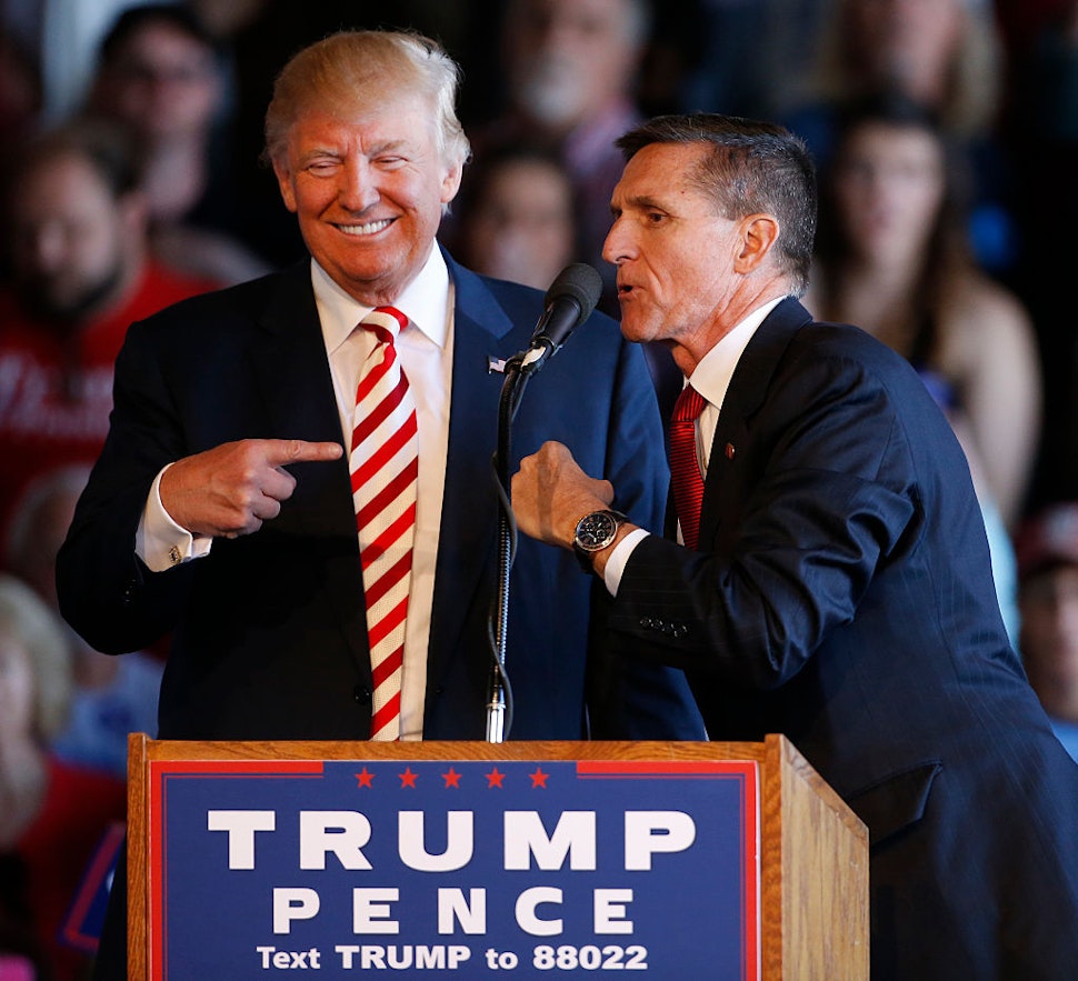 Republican presidential candidate Donald Trump (L) jokes with retired Gen. Michael Flynn as they speak at a rally at Grand Junction Regional Airport on October 18, 2016 in Grand Junction Colorado.