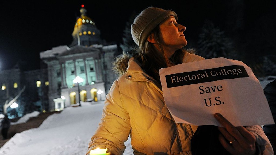 Ruth Fulton, 44, demonstrates during a candlelight vigil against US President-elect Donald Trump outside the Colorado Capitol building on the eve of the Electoral College vote, in Denver, Colorado on December 18, 2016. "The Electoral College is supposed to be a safeguard against exactly this sort of person," said Fulton. / AFP / Chris Schneider (Photo credit should read CHRIS SCHNEIDER/AFP via Getty Images)