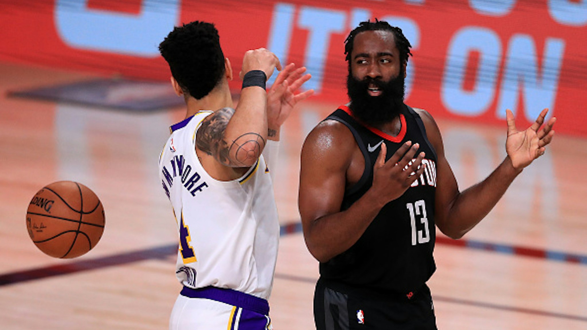 LAKE BUENA VISTA, FLORIDA - SEPTEMBER 12: James Harden #13 of the Houston Rockets reacts with Danny Green #14 of the Los Angeles Lakers during the third quarter in Game Five of the Western Conference Second Round during the 2020 NBA Playoffs at AdventHealth Arena at the ESPN Wide World Of Sports Complex on September 12, 2020 in Lake Buena Vista, Florida. NOTE TO USER: User expressly acknowledges and agrees that, by downloading and or using this photograph, User is consenting to the terms and conditions of the Getty Images License Agreement.