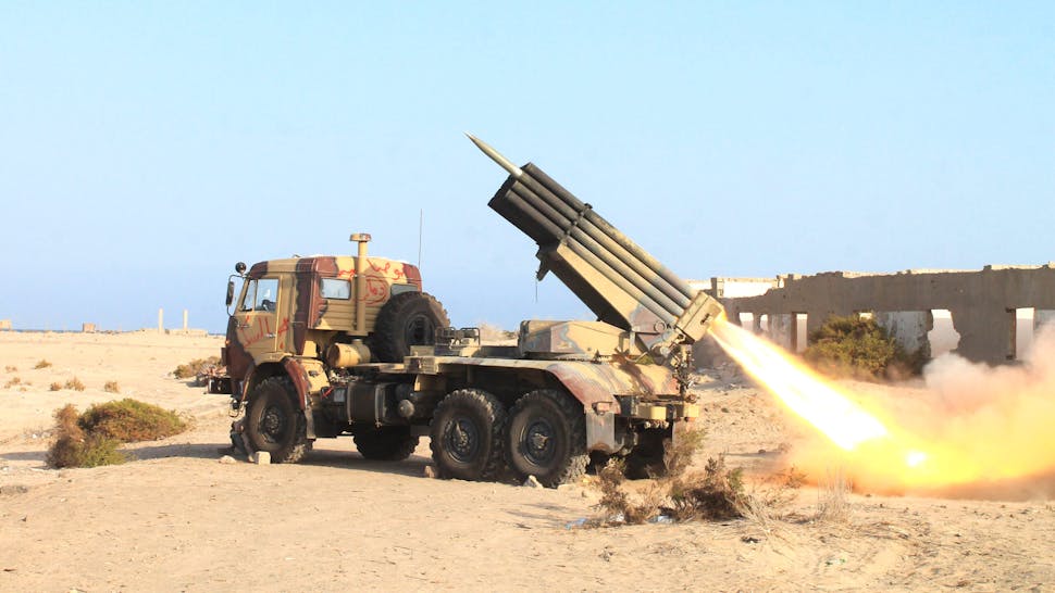 YEMEN-CONFLICT Armed militiamen loyal to Yemen's fugitive President Abderabbo Mansour Hadi launch a rocket during reported clashes with Huthi rebels in the port city of Aden's Breiqa district, on April 25, 2015. The Saudi-led coalition has kept up air strikes days after announcing its campaign was entering a new phase aimed at resuming the political process, delivering aid and fighting "terrorism". The fighting has raised fears that Yemen could become a new front in a proxy war between Sunni-ruled Gulf monarchies and Shiite Iran.