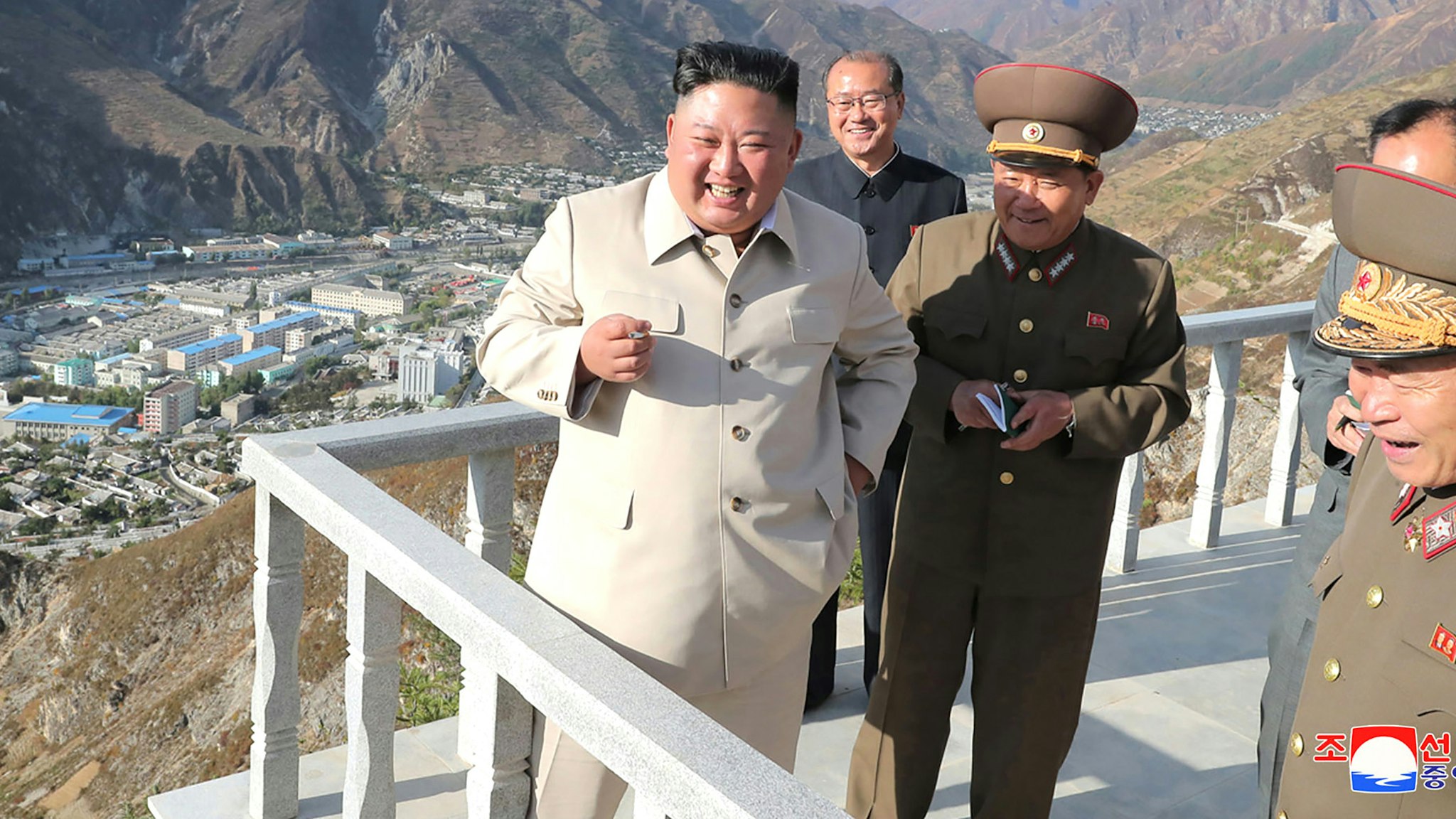 This undated picture released from North Korea's official Korean Central News Agency (KCNA) on October 14, 2020 shows North Korean leader Kim Jong Un (L) inspecting the rehabilitation site in the Komdok area of South Hamgyong Province, which was damaged by the typhoon.