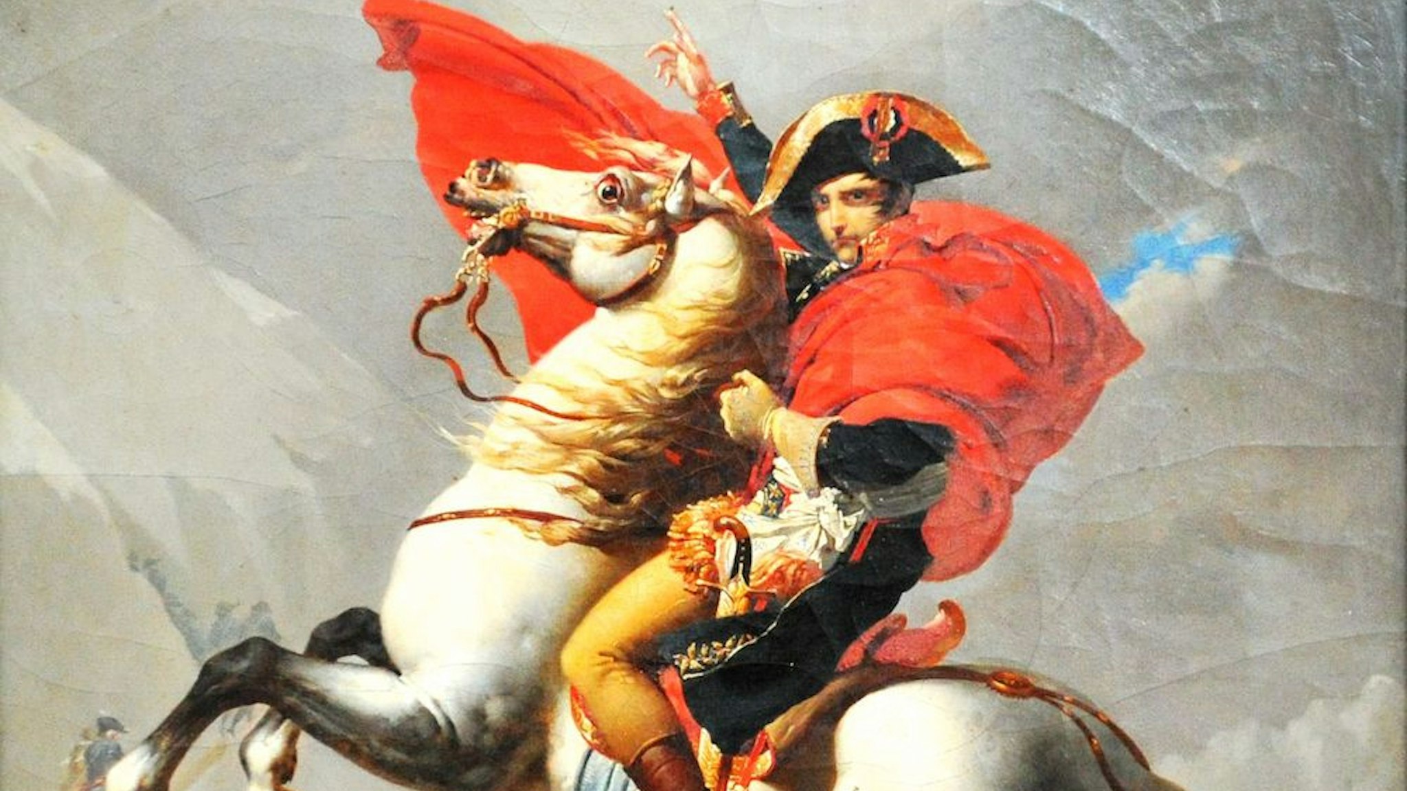 Workers present the oil painting of Napoleon Bonaparte Crossing the Alps by the French artist Jacques-Louis David for an art show featuring the French emporer in Qingdao in east China's Shandong province Tuesday, Aug. 04, 2020. Nearly 200 artifacts, most of which lent from French collector Pierre Jean Chalencion, will be shown till mid-November.
