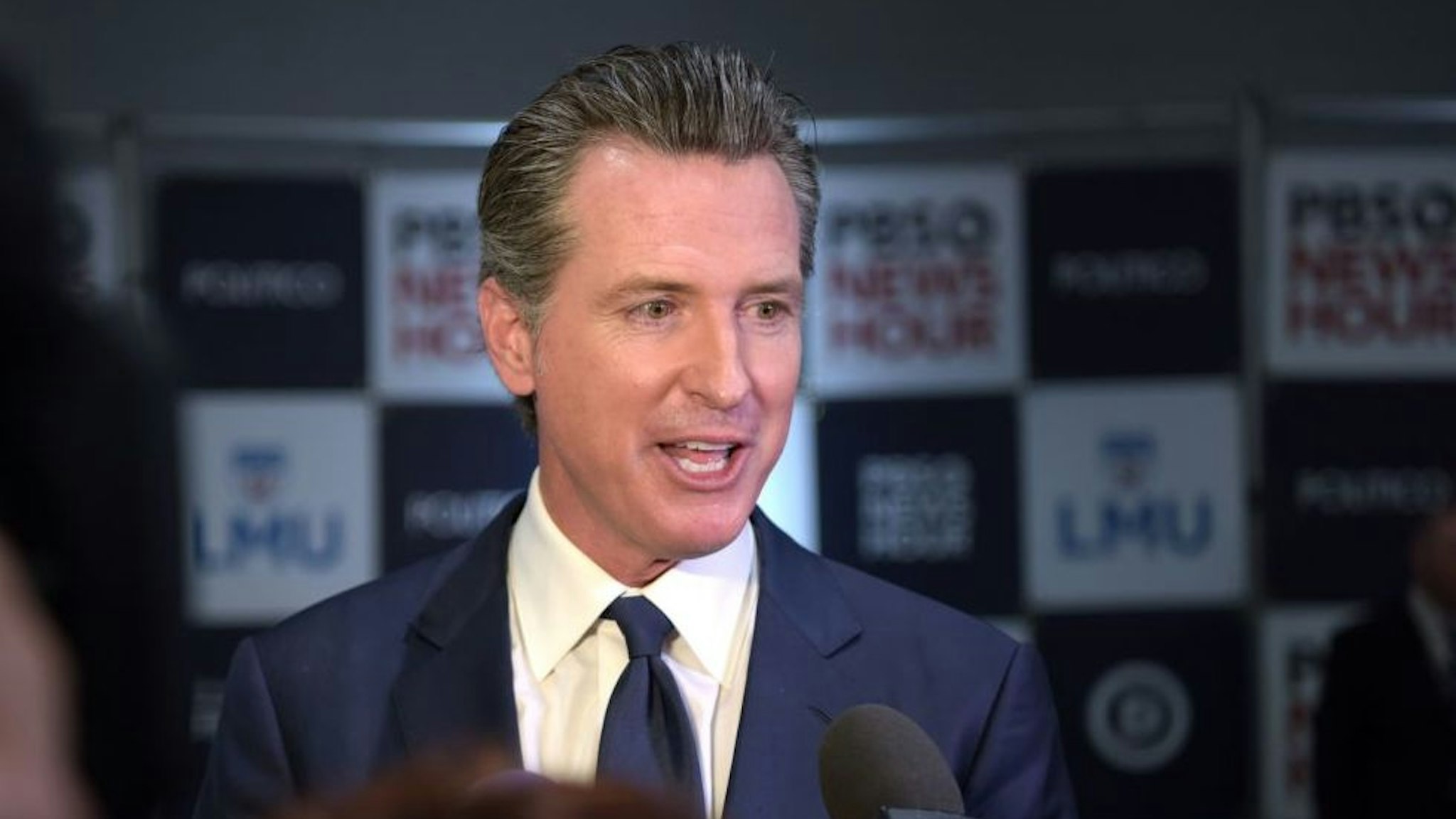 California Governor Gavin Newsom speaks to the press in the spin room after the sixth Democratic primary debate of the 2020 presidential campaign season co-hosted by PBS NewsHour &amp; Politico at Loyola Marymount University in Los Angeles, California on December 19, 2019.