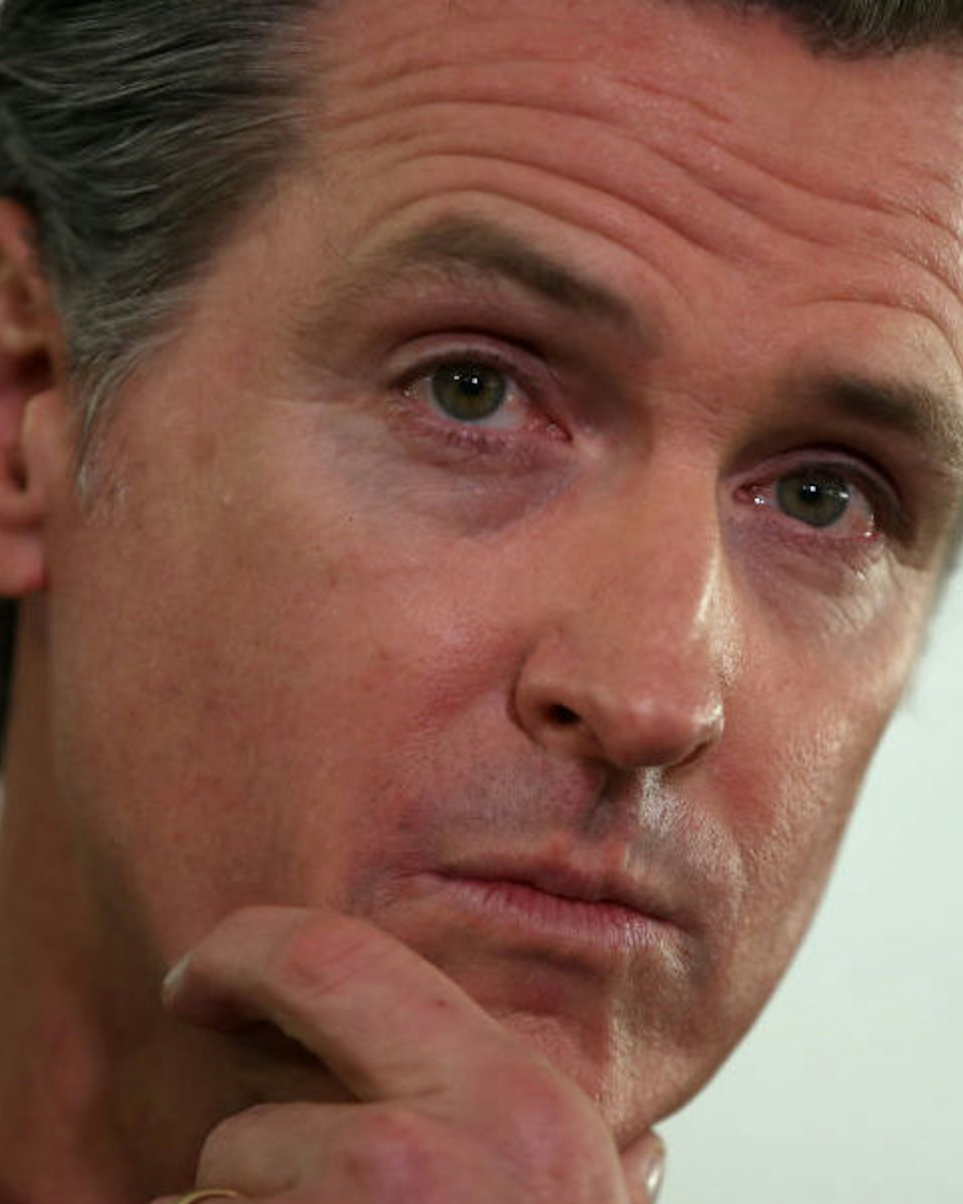 OAKLAND, CALIFORNIA - JANUARY 16: California Gov. Gavin Newsom looks on during a a news conference about the state's efforts on the homelessness crisis on January 16, 2020 in Oakland, California. Newsom was joined by Oakland Mayor Libby Schaaf to announce that Oakland will receive 15 unused FEMA trailers for the city to use as temporary housing and as mobile health and social services clinics for the homeless. Newsom signed on executive order on January 8 to deploy 100 trailers and crisis response teams to areas in need across the state.