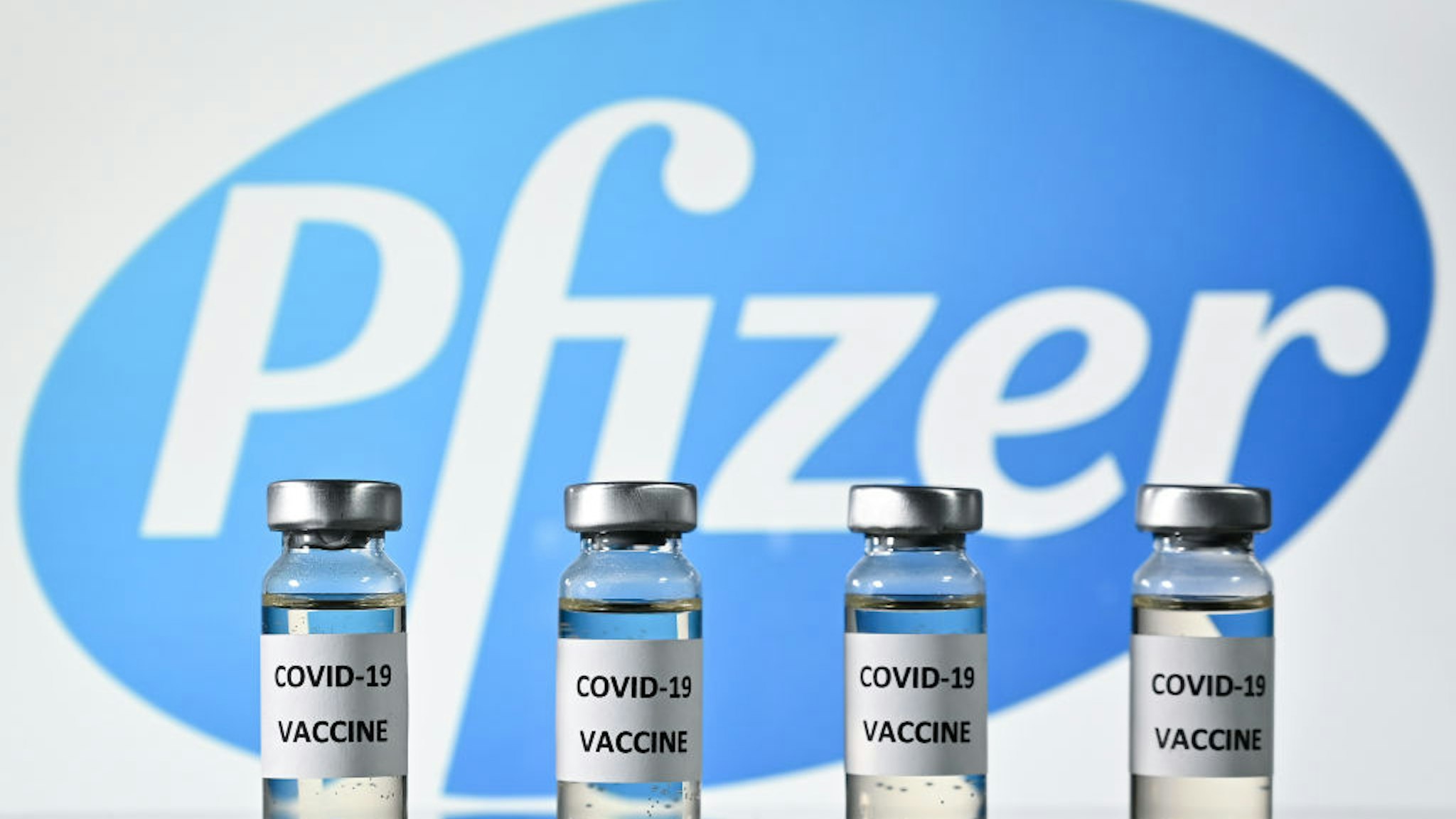 An illustration picture shows vials with Covid-19 Vaccine stickers attached, with the logo of US pharmaceutical company Pfizer, on November 17, 2020.