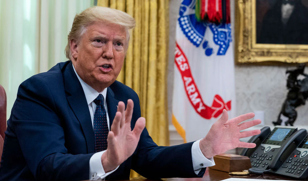 President Donald Trump with Attorney General William Barr, make remarks before signsing an executive order in the Oval Office that will punish Facebook, Google and Twitter for the way they police content online, Thursday, May 28, 2020. ( Photo by Doug Mills/The New York Times)