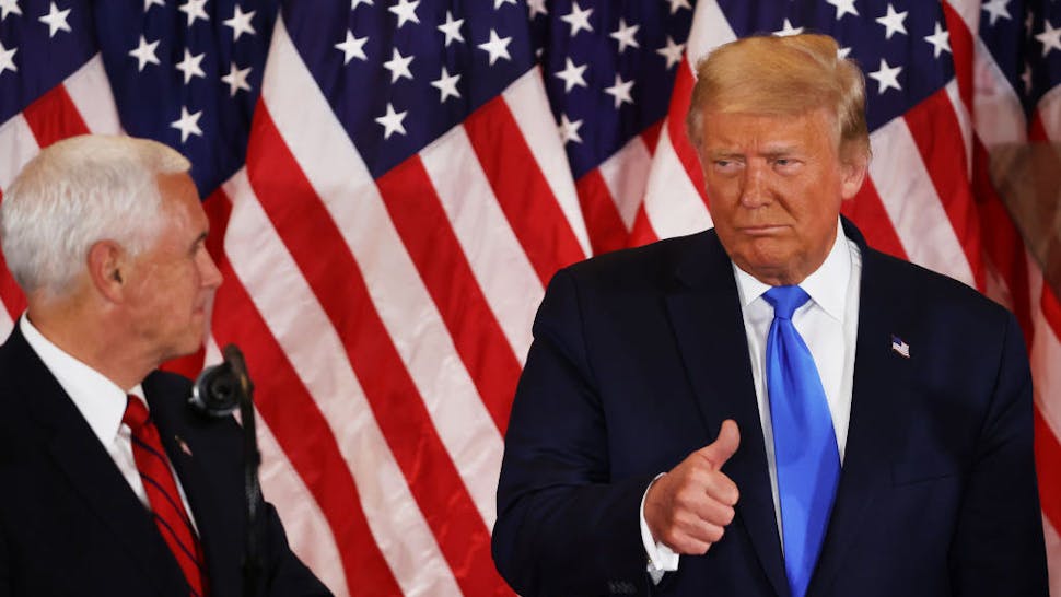 President Trump WASHINGTON, DC - NOVEMBER 04: U.S. President Donald Trump gestures to Vice President Mike Pence on election night in the East Room of the White House in the early morning hours of November 04, 2020 in Washington, DC. Trump spoke shortly after 2am with the presidential race against Democratic presidential nominee Joe Biden still too close to call. (Photo by Chip Somodevilla/Getty Images)